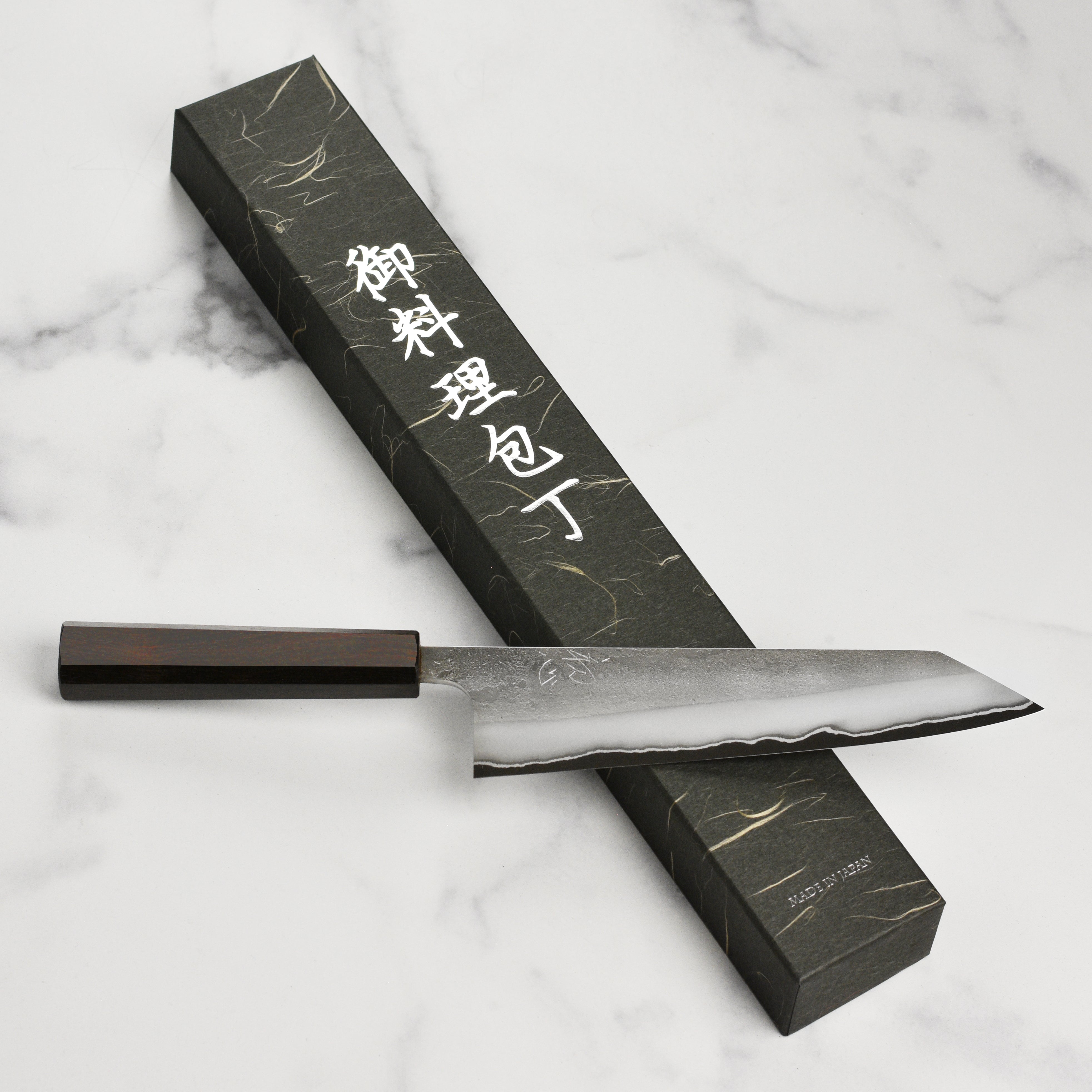 Elegant presentation of the Yoshikane 8.25" Kiritsuke knife on a cutting board with vegetables.