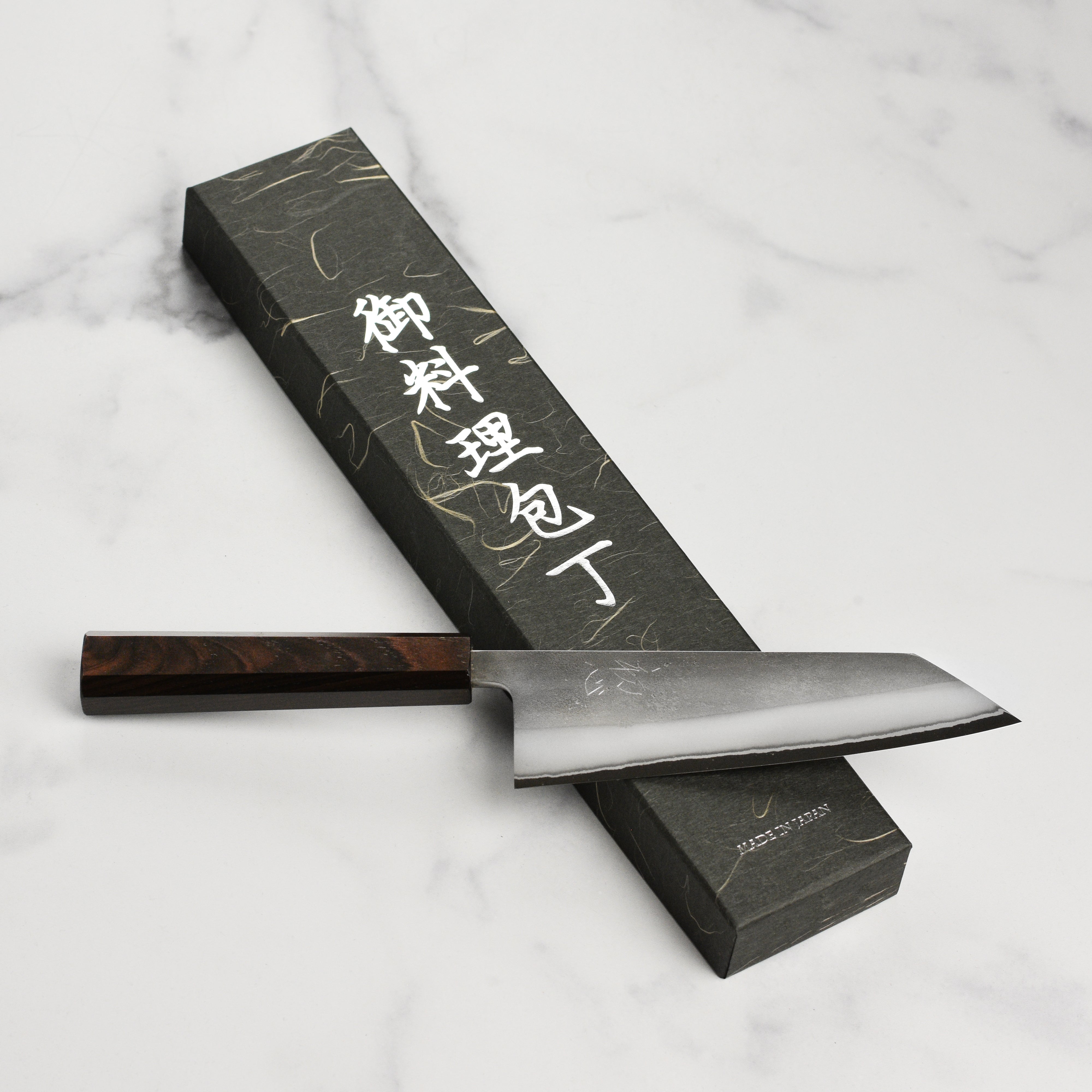 Close-up of the Yoshikane Bunka Knife showcasing its stainless steel finish.