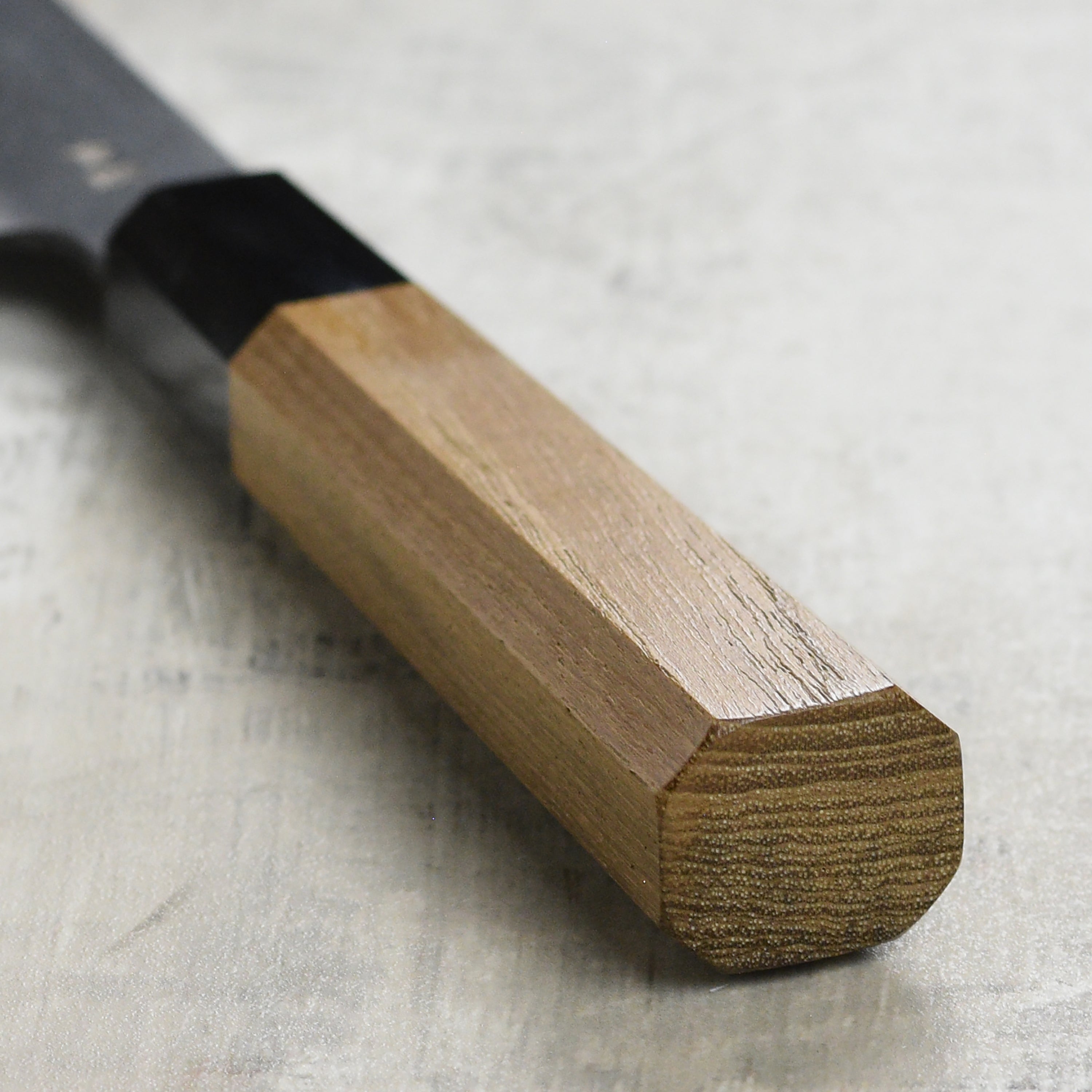 Close-up of the blade of the Aogami steel gyuto knife highlighting the kurouchi finish