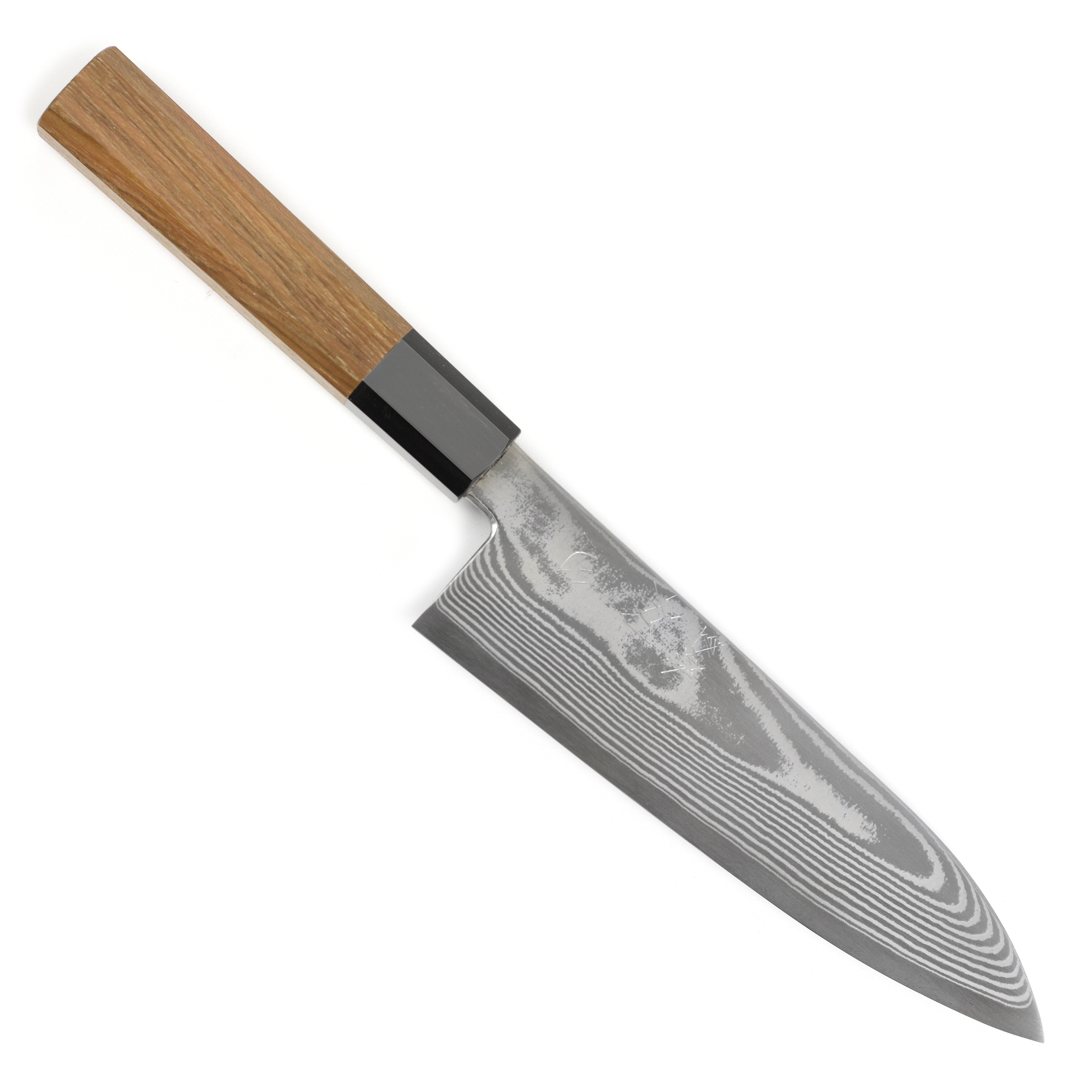 Chef slicing vegetables using the 7-inch santoku knife in a professional kitchen