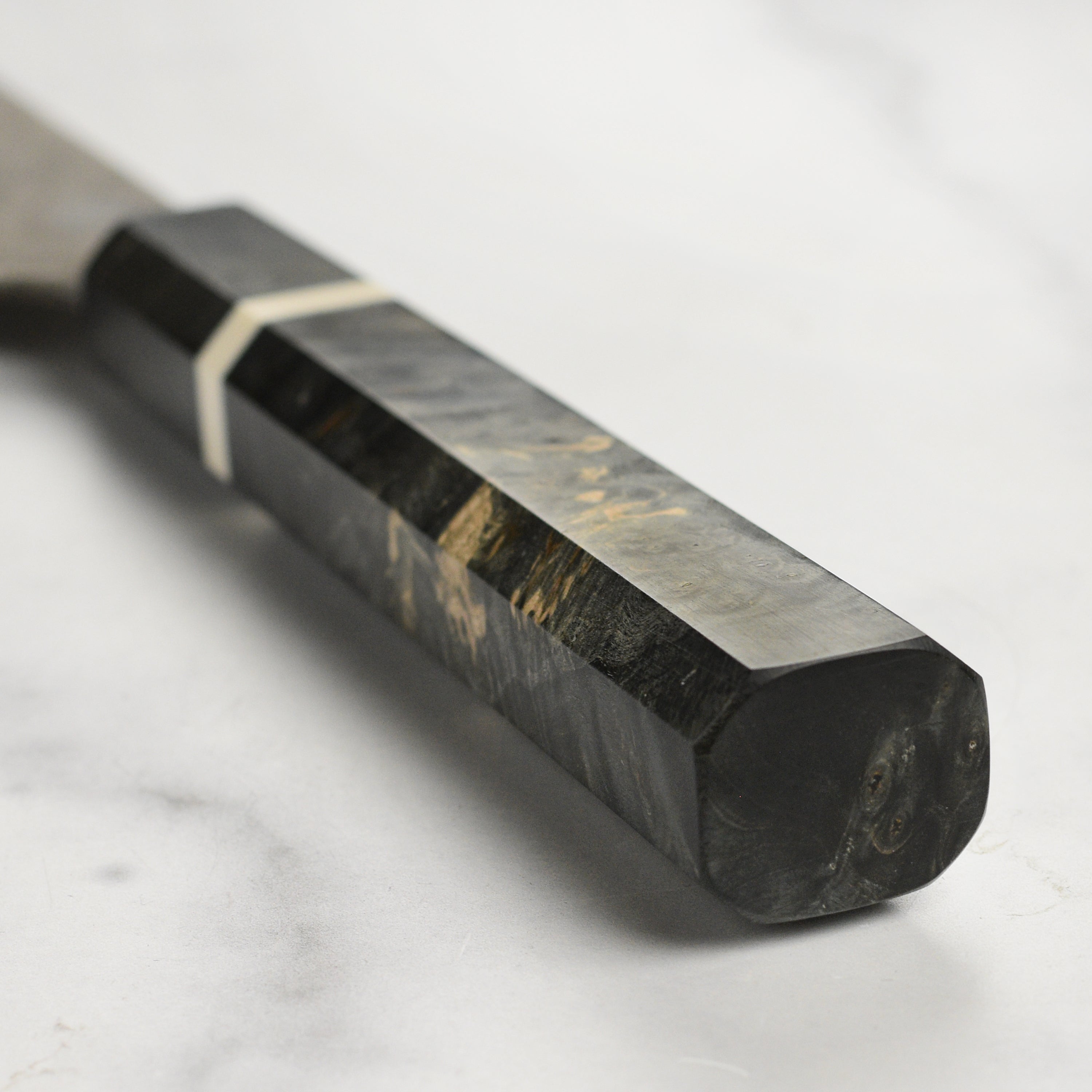 Chef using the Nigara Ginsan Damascus Sujihiki Knife to slice fish with precision.