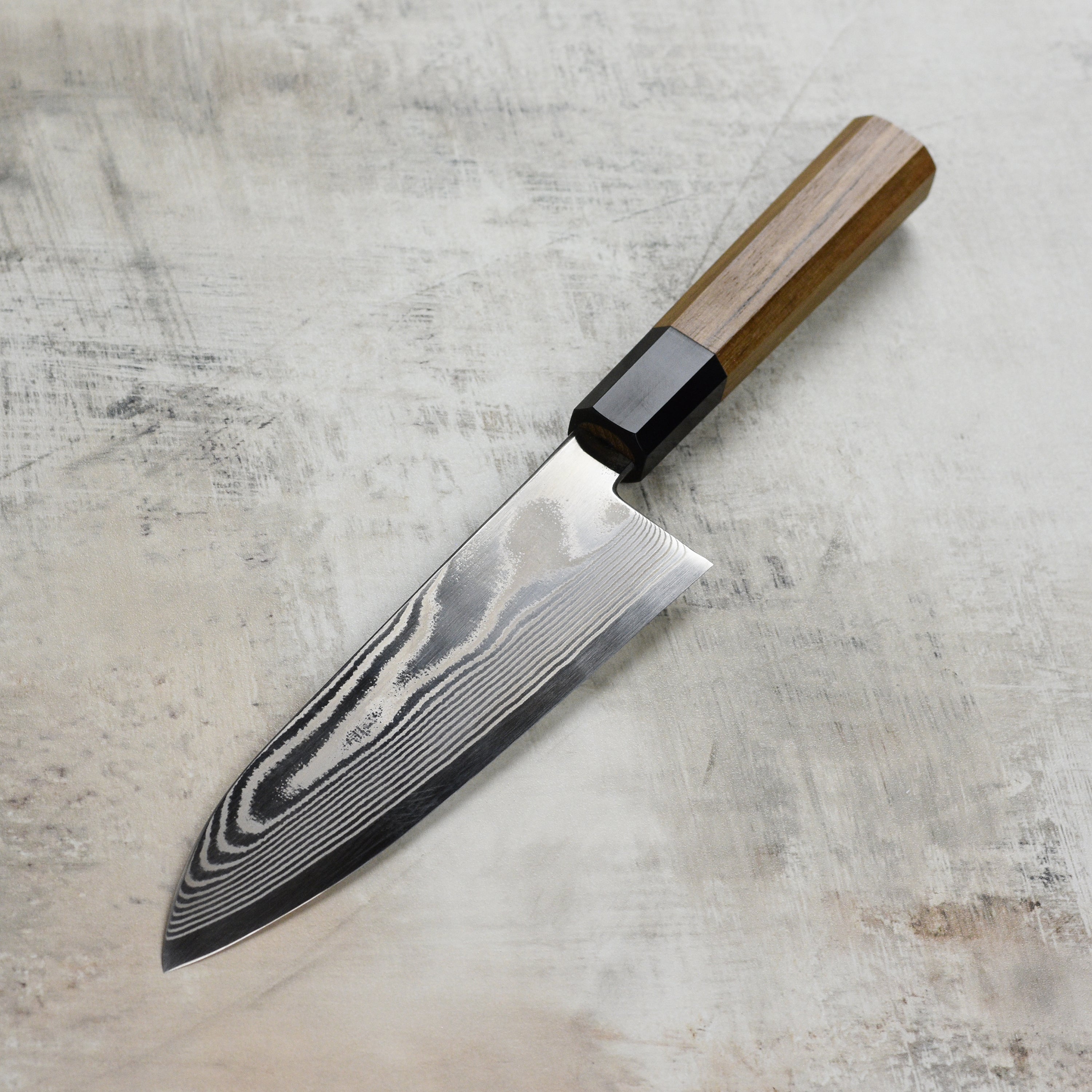 Close-up of the Ginsan steel blade showcasing craftsmanship and damascus pattern