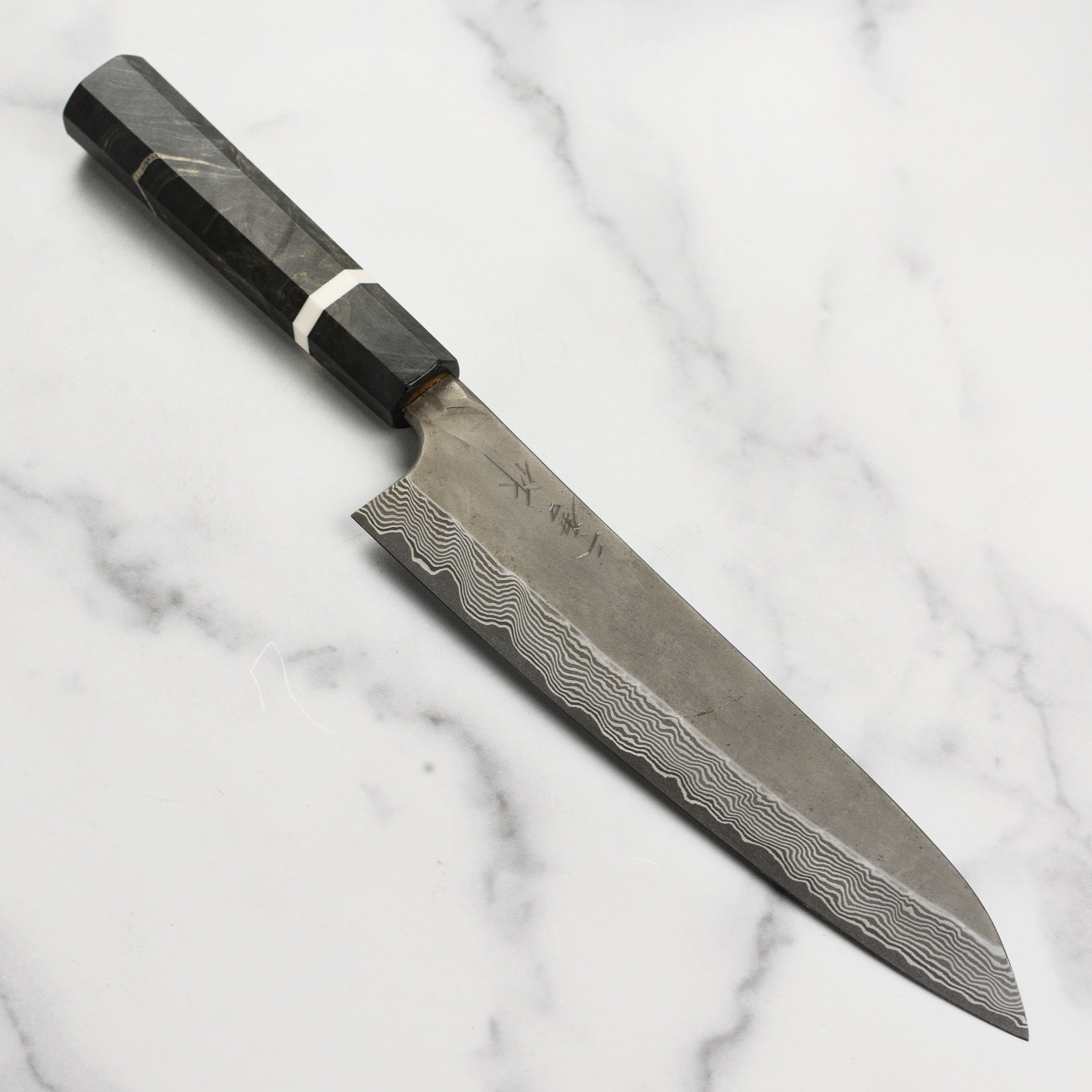 Nigara Ginsan Kurozome Damascus Gyuto knife with detailed steel pattern for professional chefs