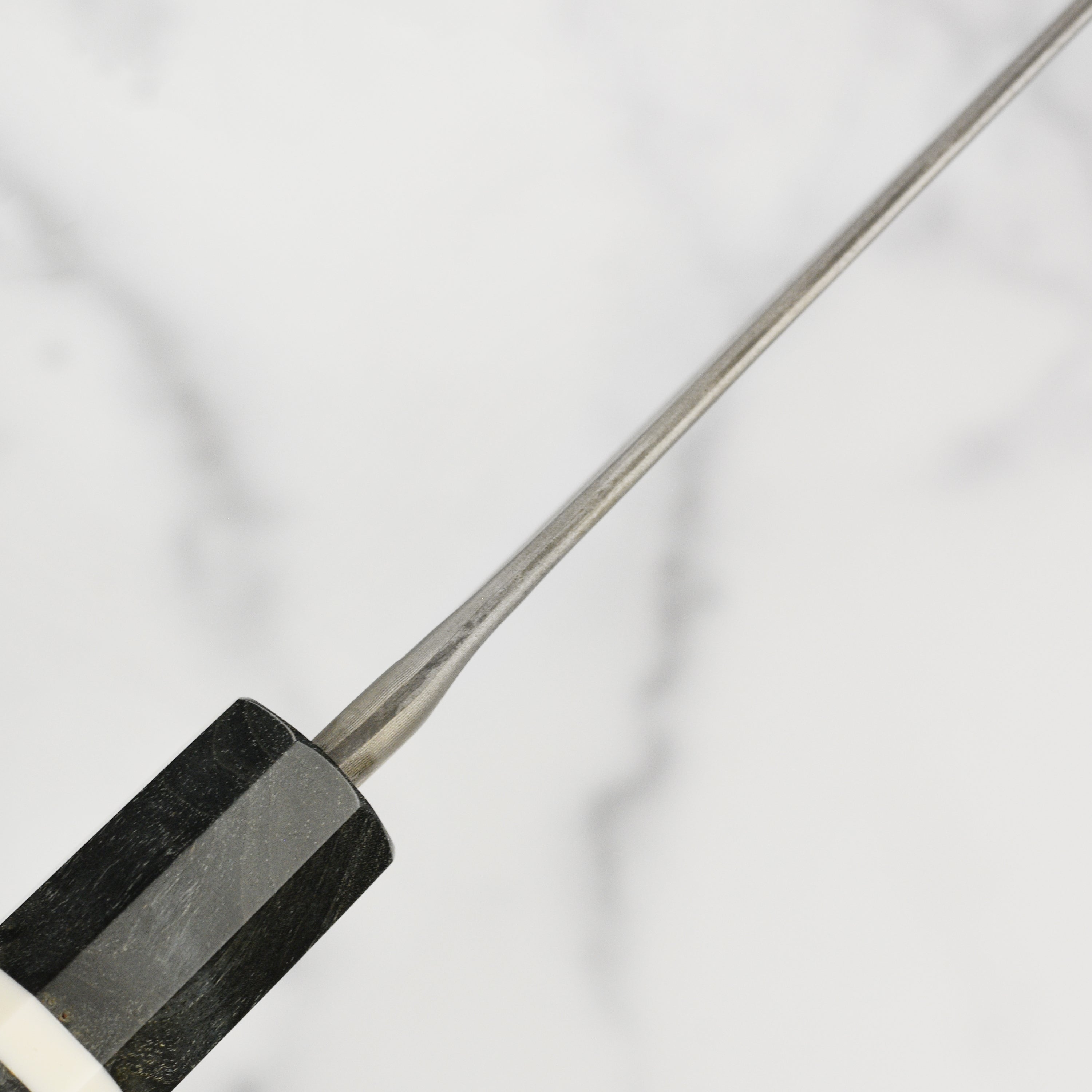 Ergonomic handle and sharp edge of the Nigara Ginsan Damascus Gyuto for home cooking