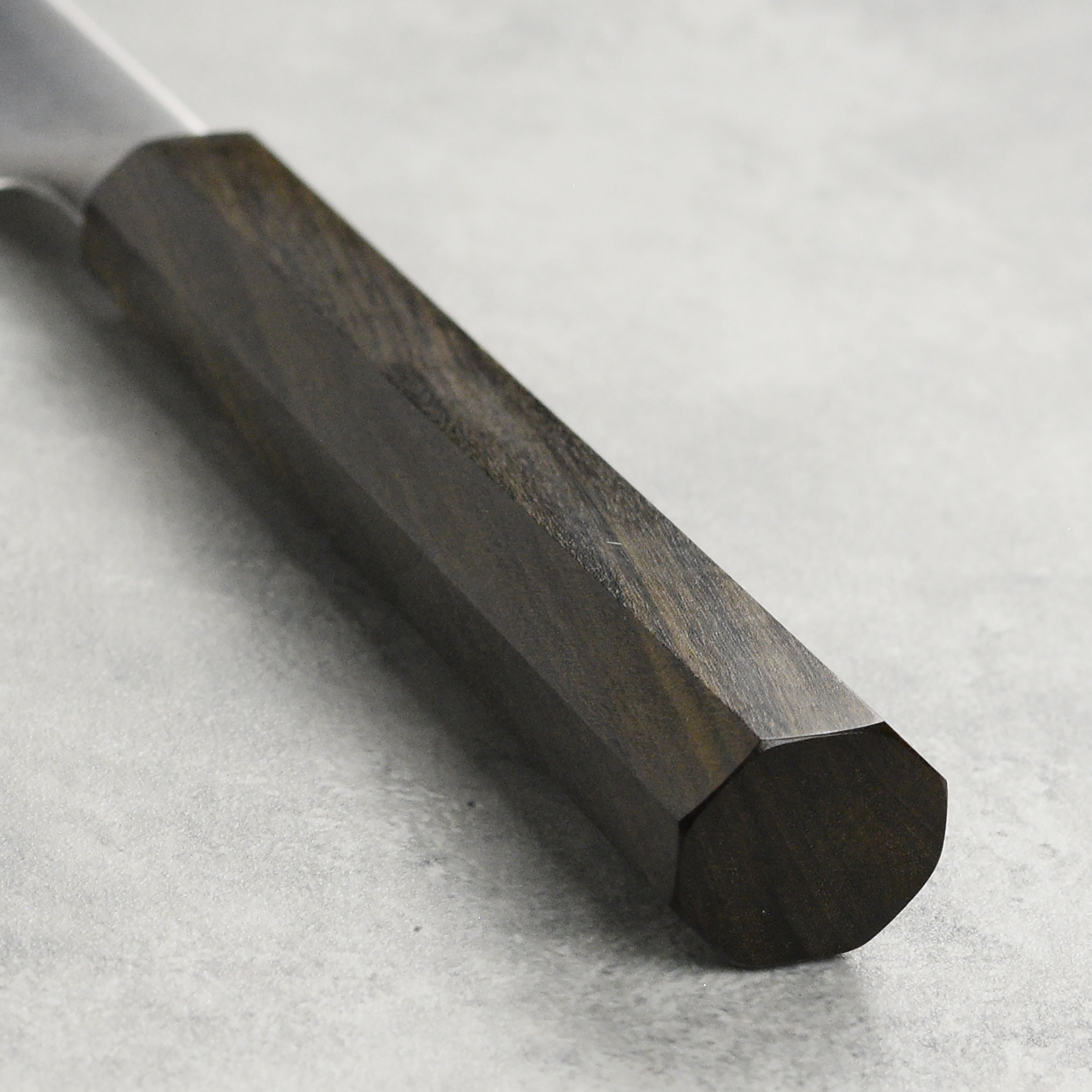 A close-up of the Hatsukokoro Hayabusa HAP40 petty knife in action, expertly slicing fresh vegetables.