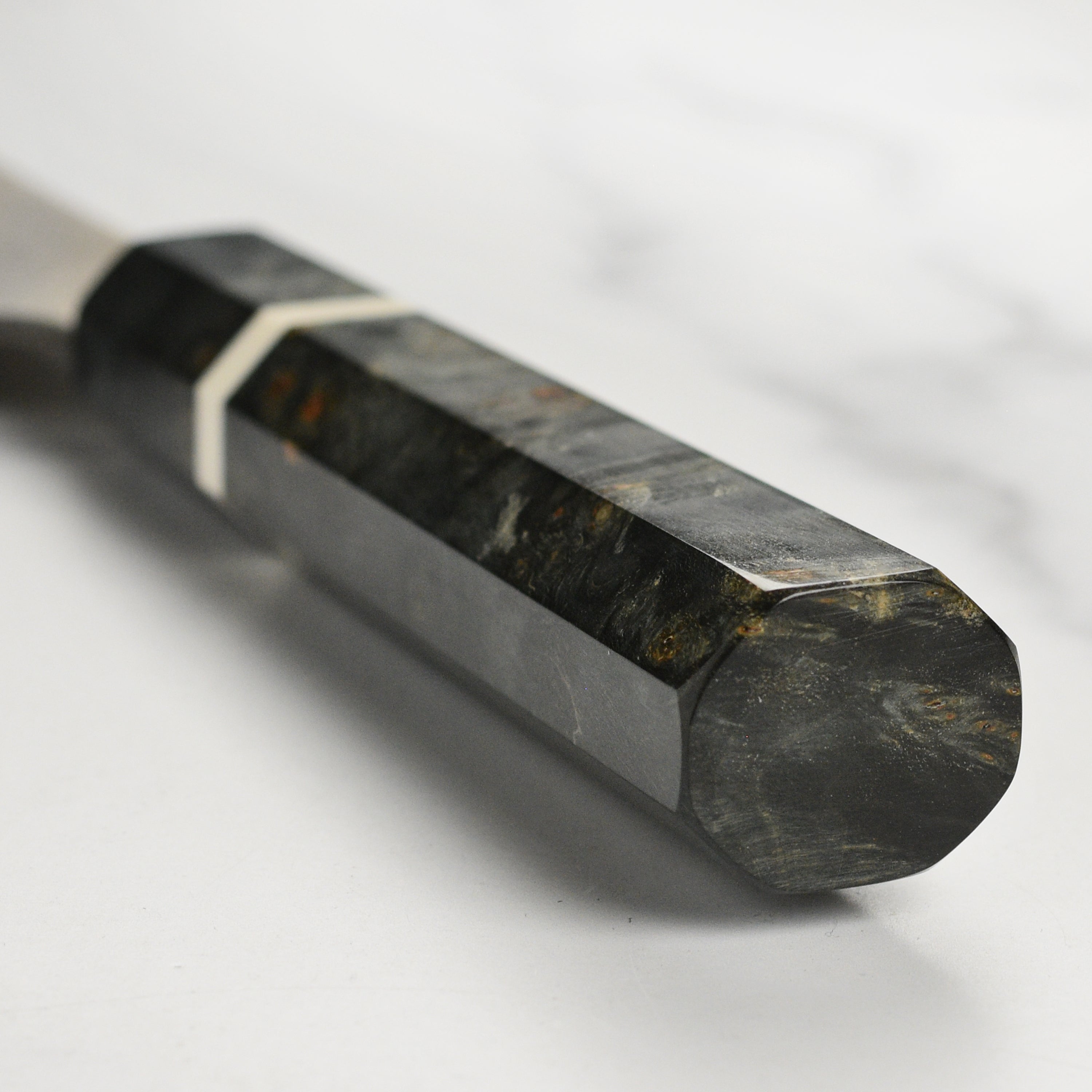 A chef using the 9.4-inch Damascus knife to slice vegetables with precision.