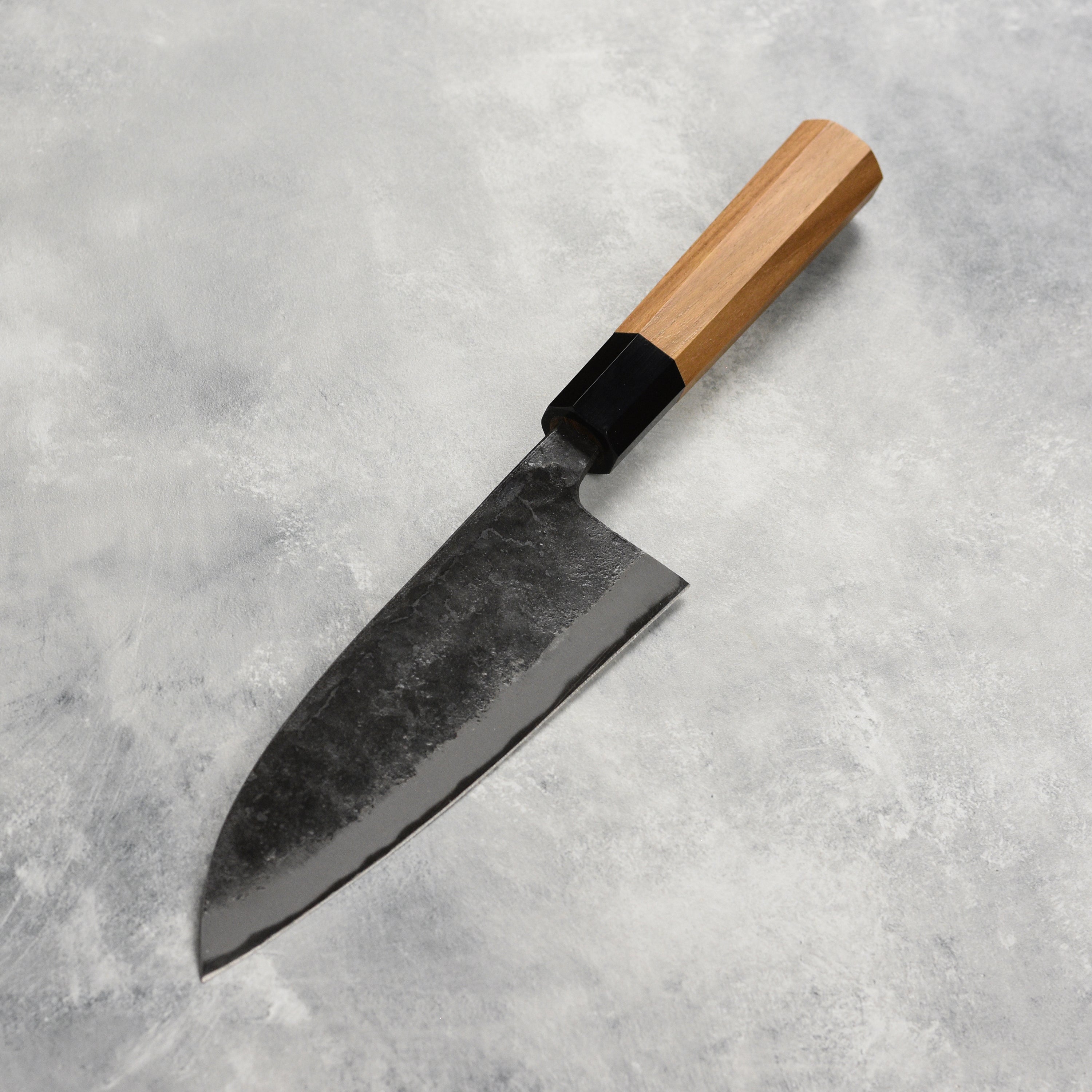 Chef using the Hatsukokoro Kurokaze Aogami knife to fillet a fish, demonstrating its precision.