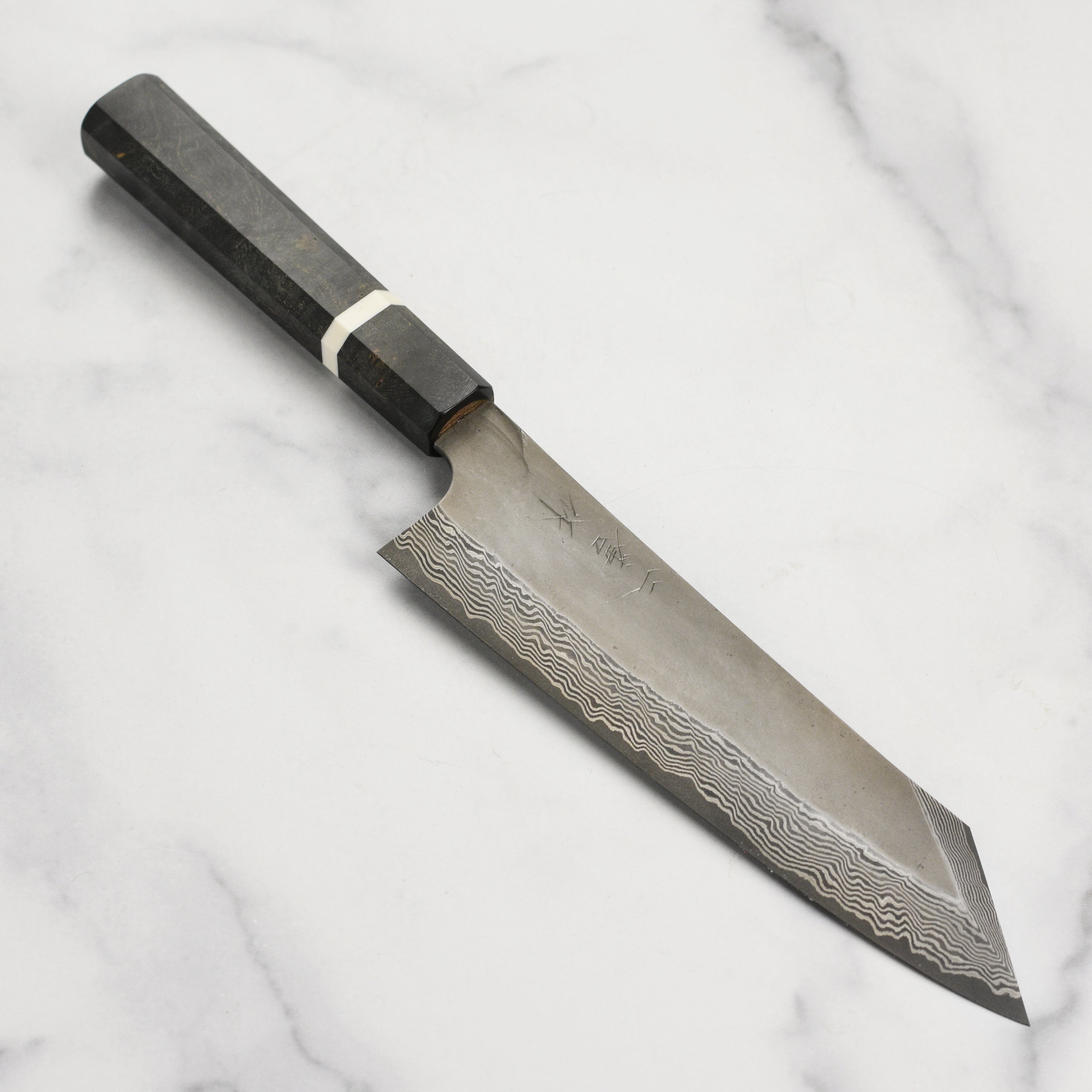 Close-up of Nigara Ginsan Kurozome Damascus kiritsuke knife blade showing intricate layered pattern