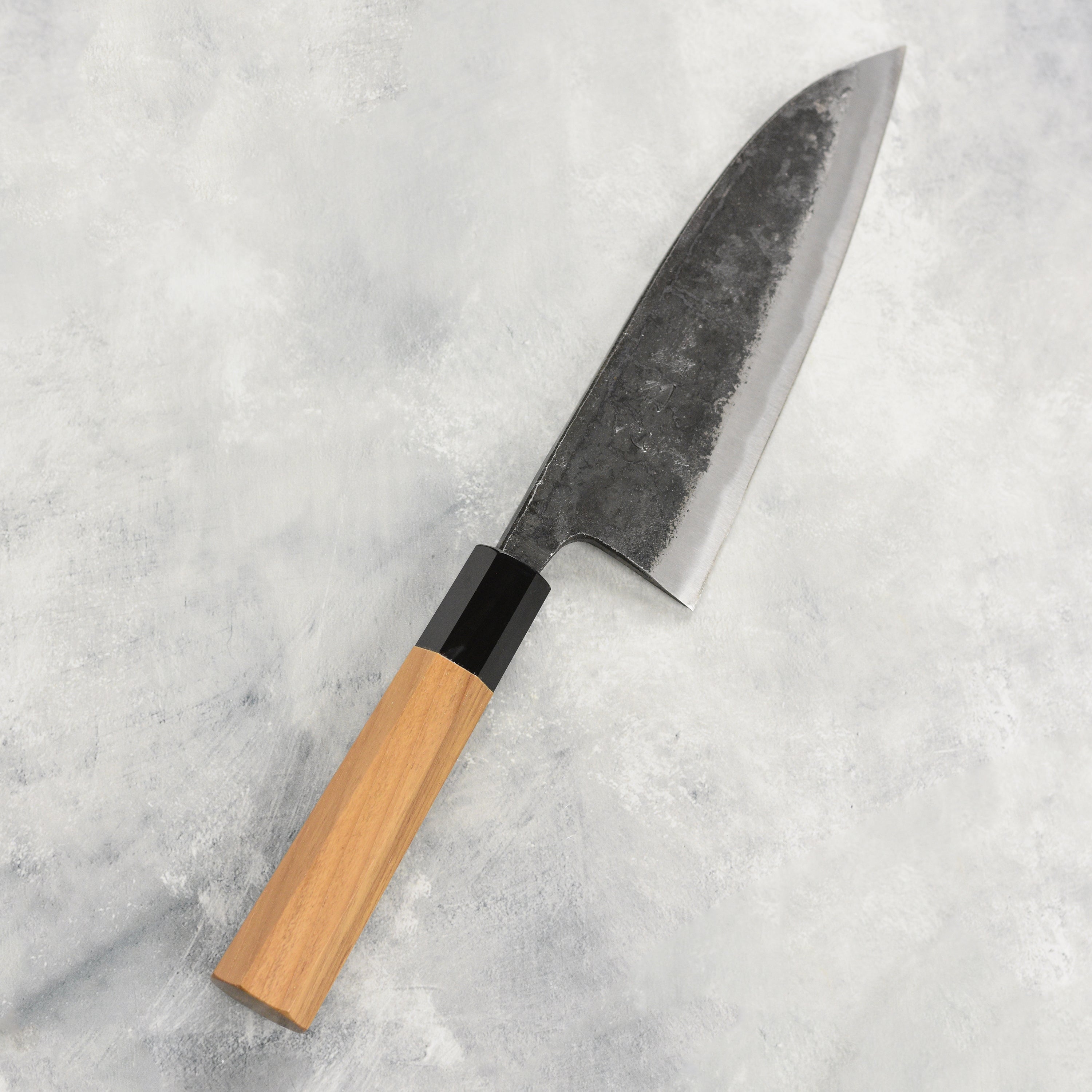 Close-up of the blade of the Hatsukokoro Kurokaze Aogami knife, highlighting the sharp edge and craftsmanship.