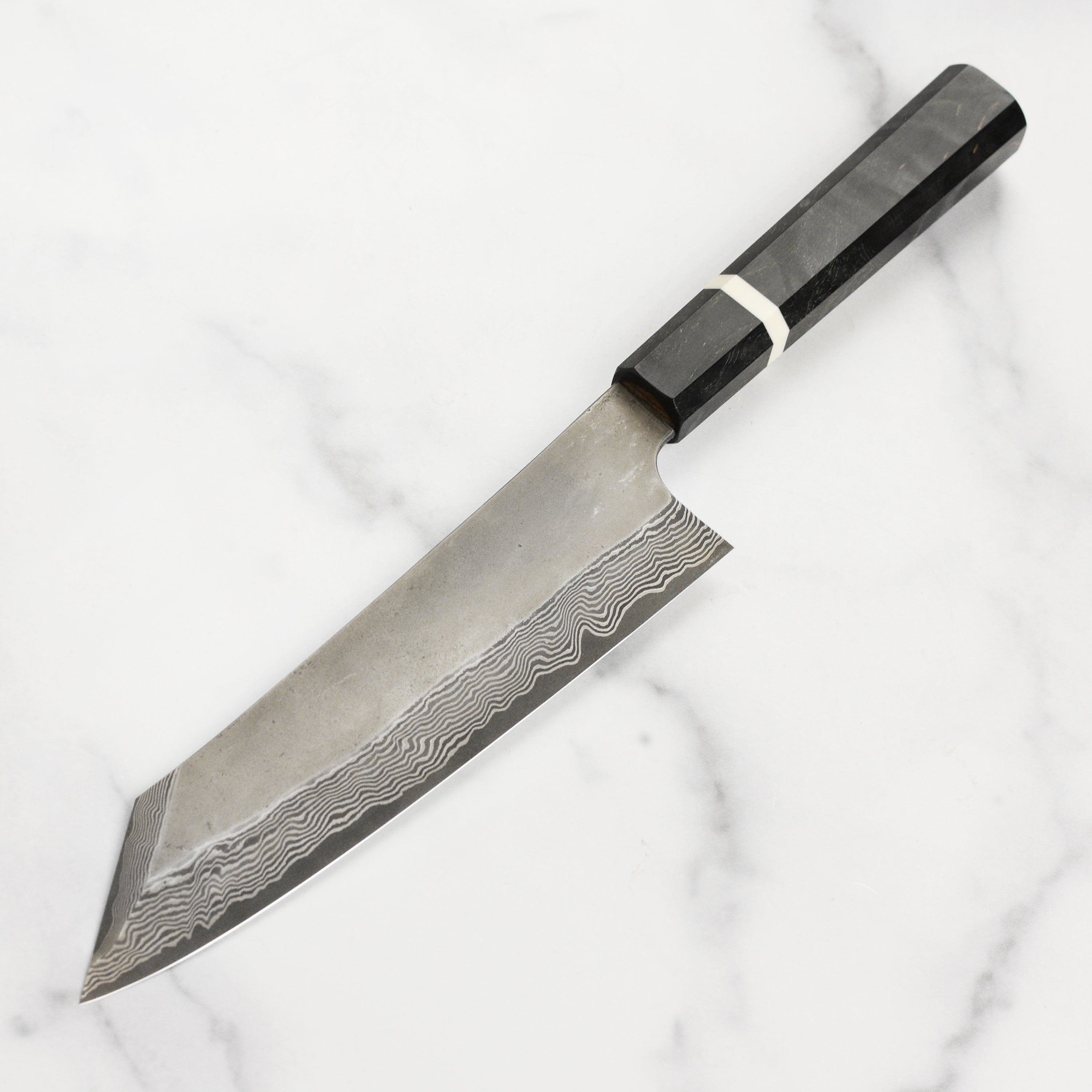Close-up of Nigara Ginsan Kurozome Damascus kiritsuke knife blade showing intricate layered pattern