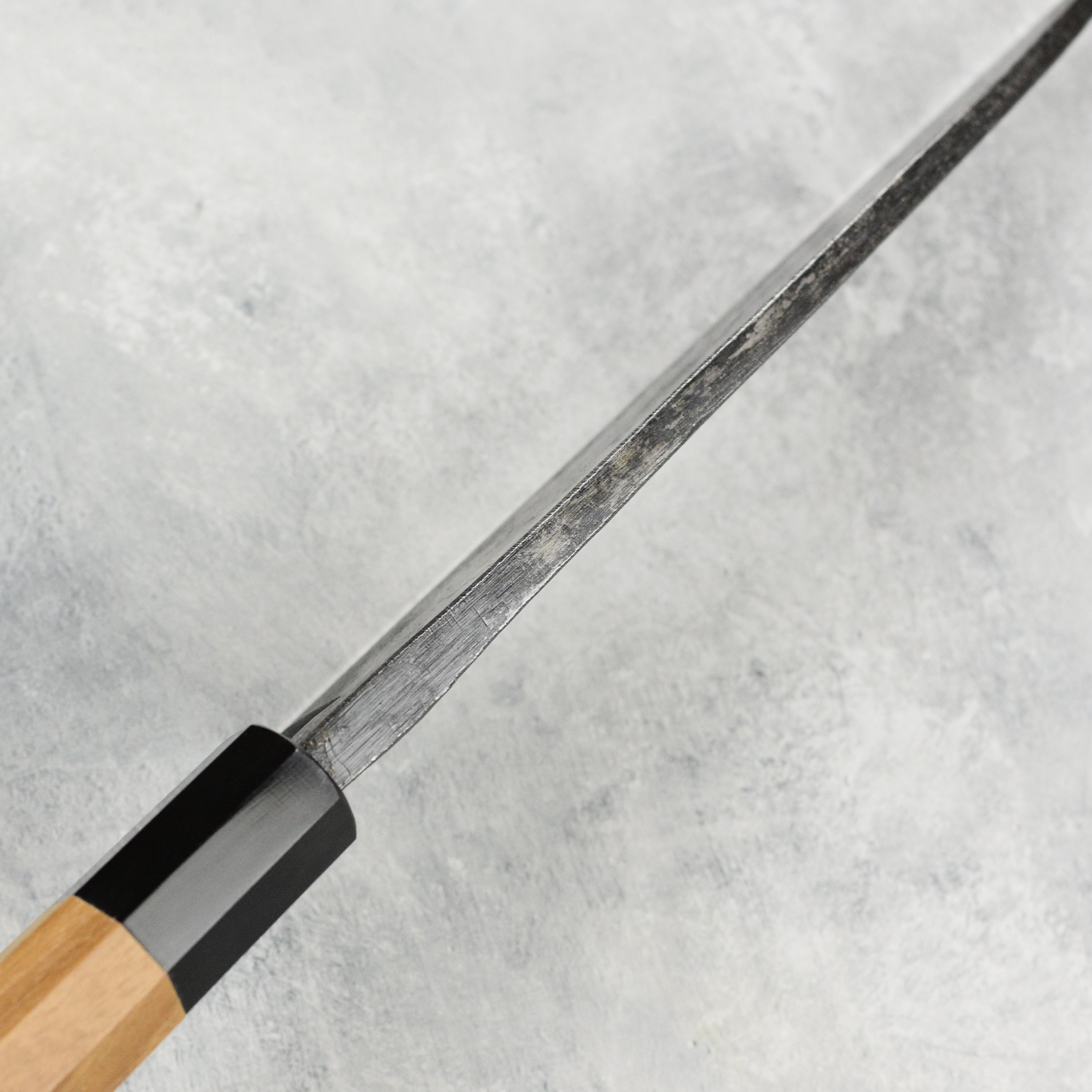Chef using the Hatsukokoro Kurokaze Aogami knife to fillet a fish, demonstrating its precision.