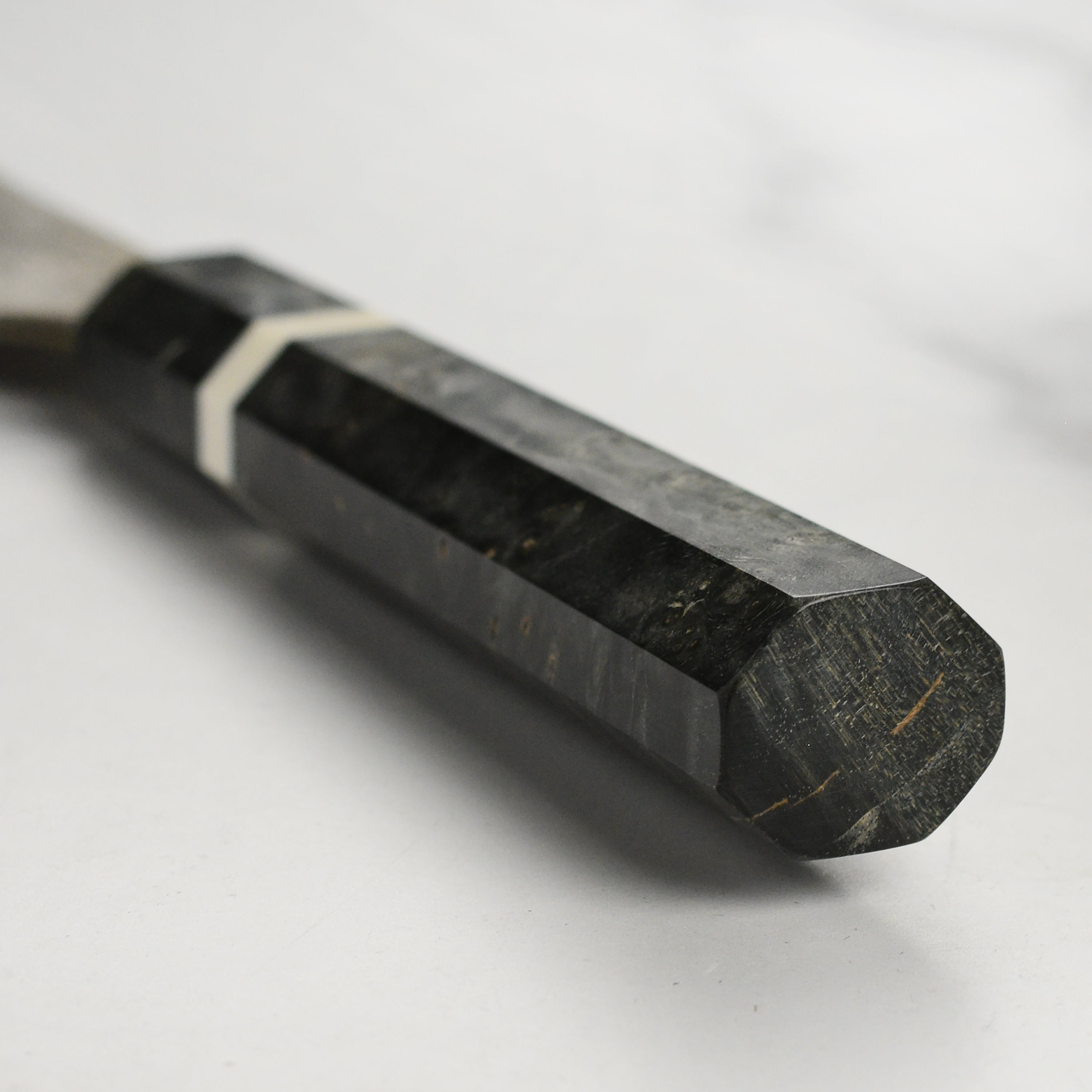 Professional chef using a damascus kiritsuke knife for vegetable prep