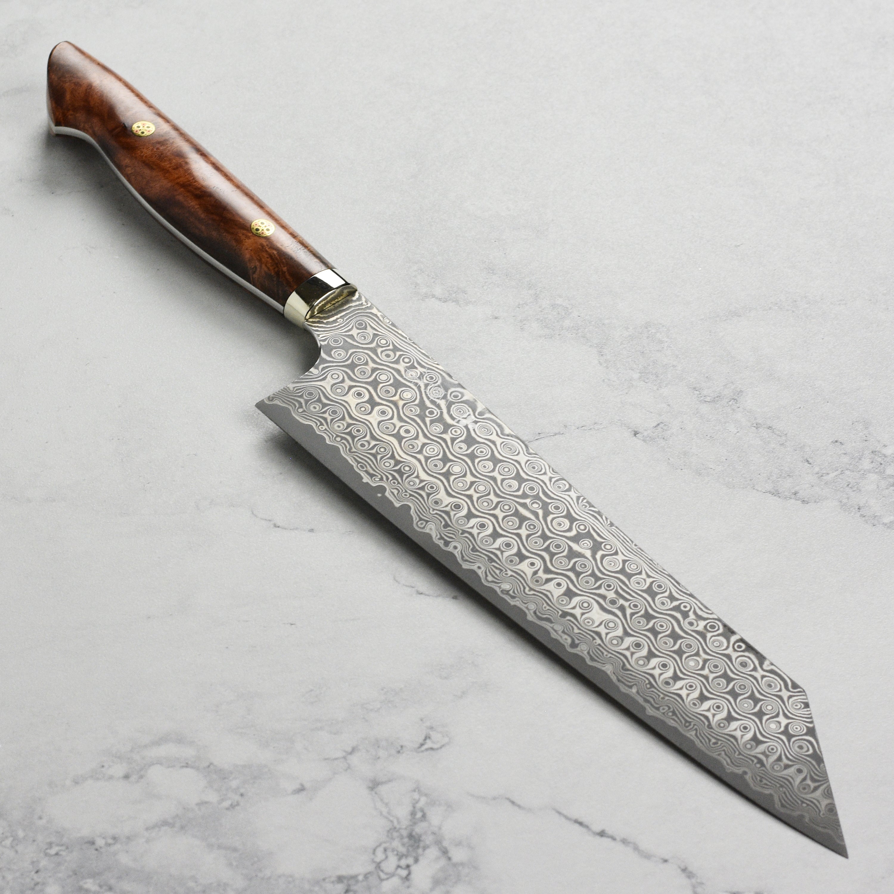 Nigara Anmon SG2 Damascus Kiritsuke knife with detailed blade pattern and quince wood handle for professional use