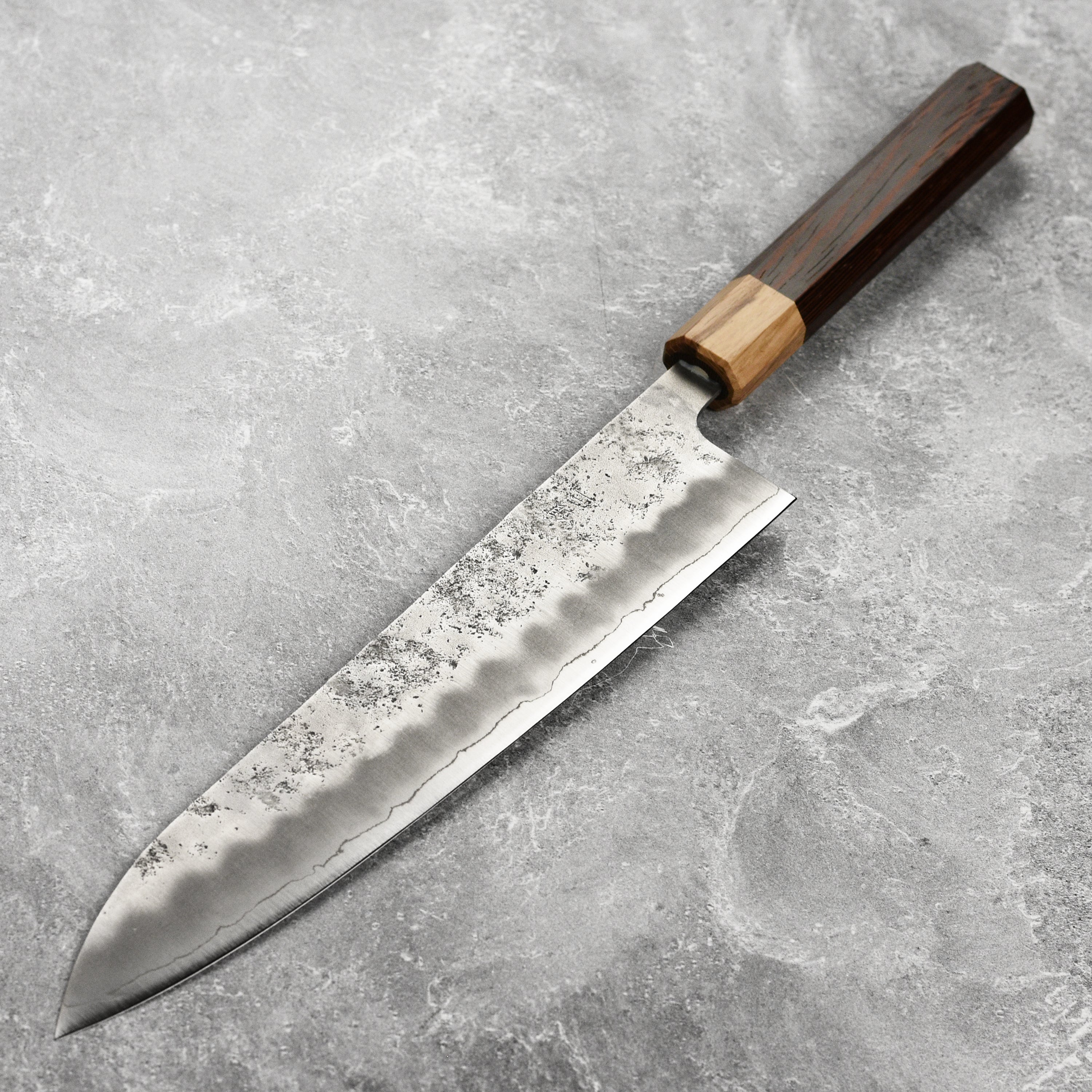 Chef slicing vegetables with the Enso Ginsan gyuto in a professional kitchen setting