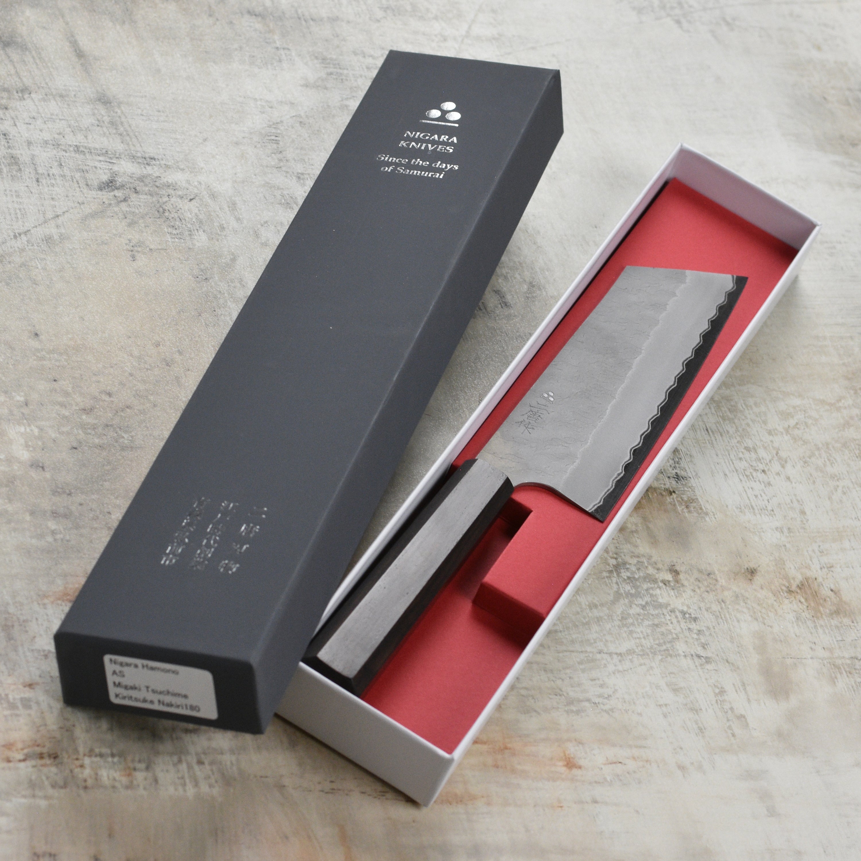 Premium Aogami Super Nakiri knife showcasing its sharp blade and tsuchime finish.