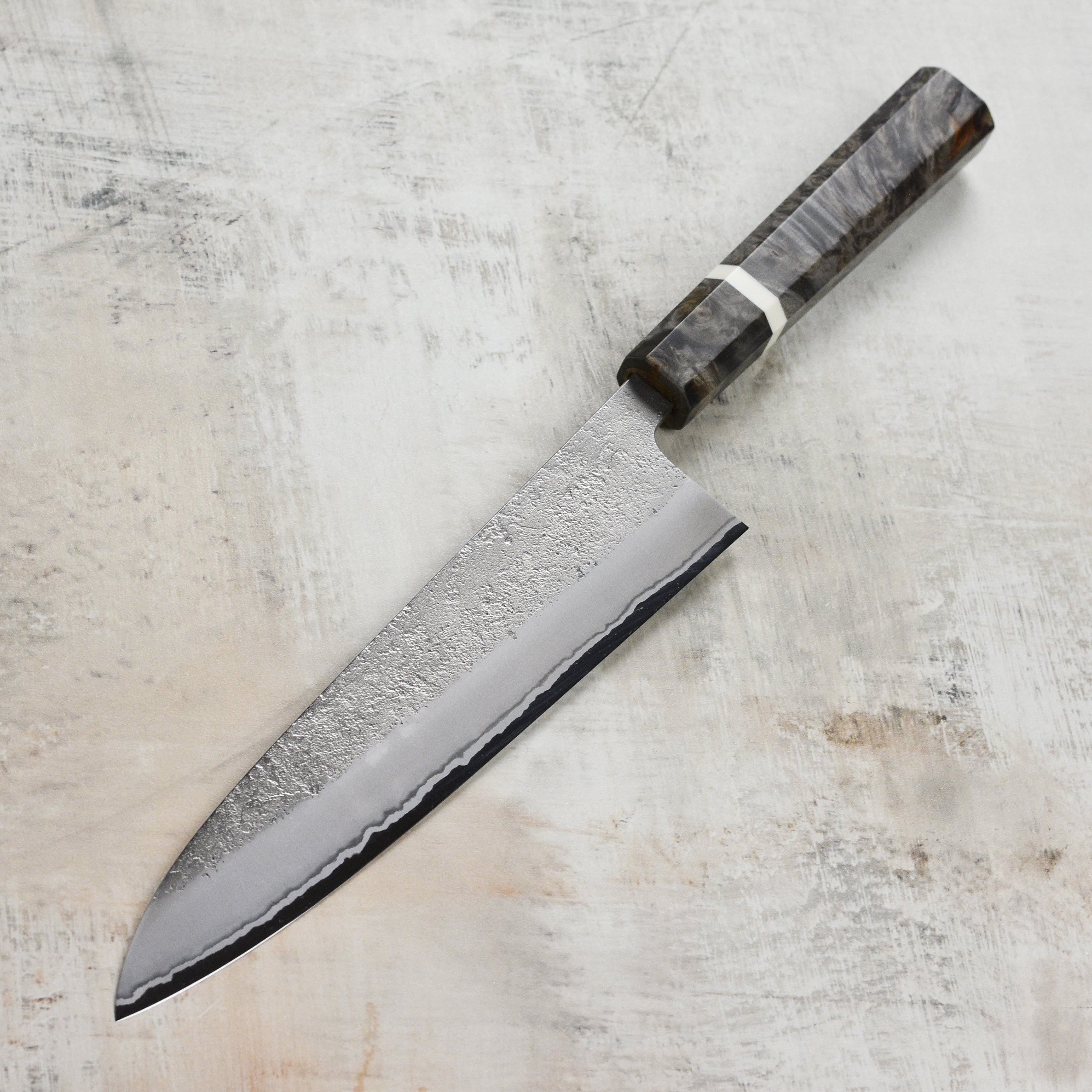 Yoshikane Gyuto Knife in action on a cutting board, showcasing its versatility for various kitchen tasks.