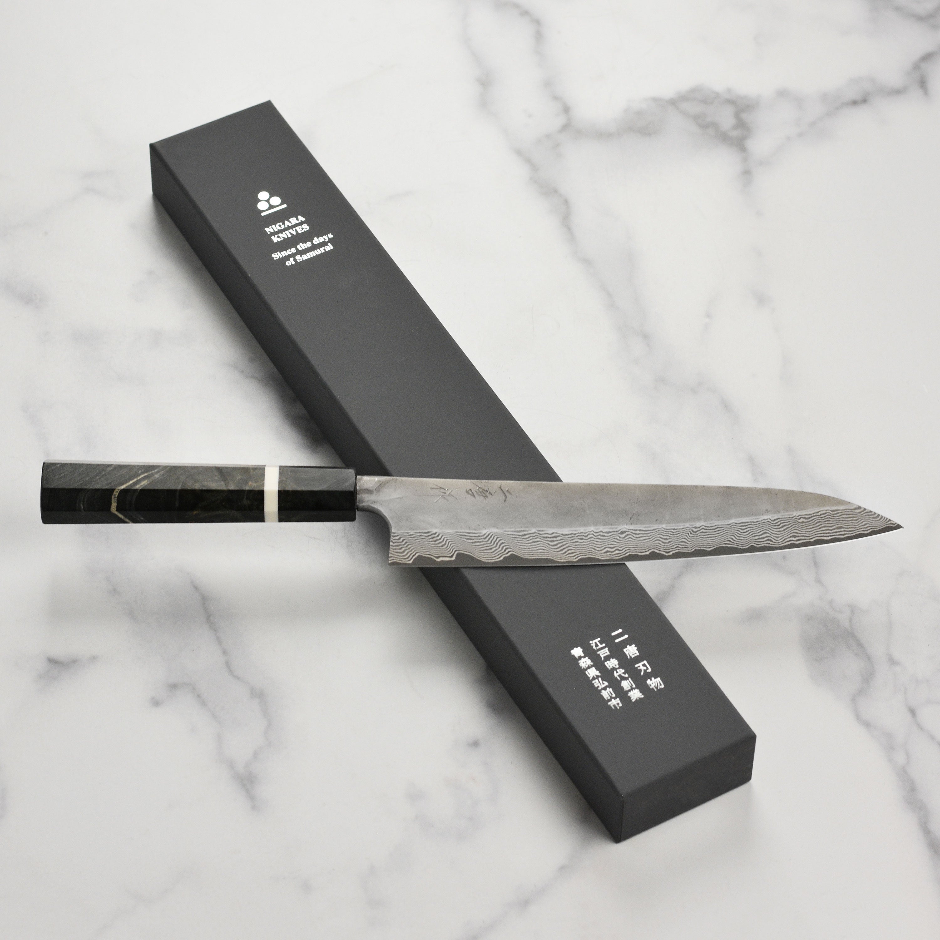 Nigara Ginsan Kurozome Damascus Gyuto knife with detailed steel pattern for professional chefs