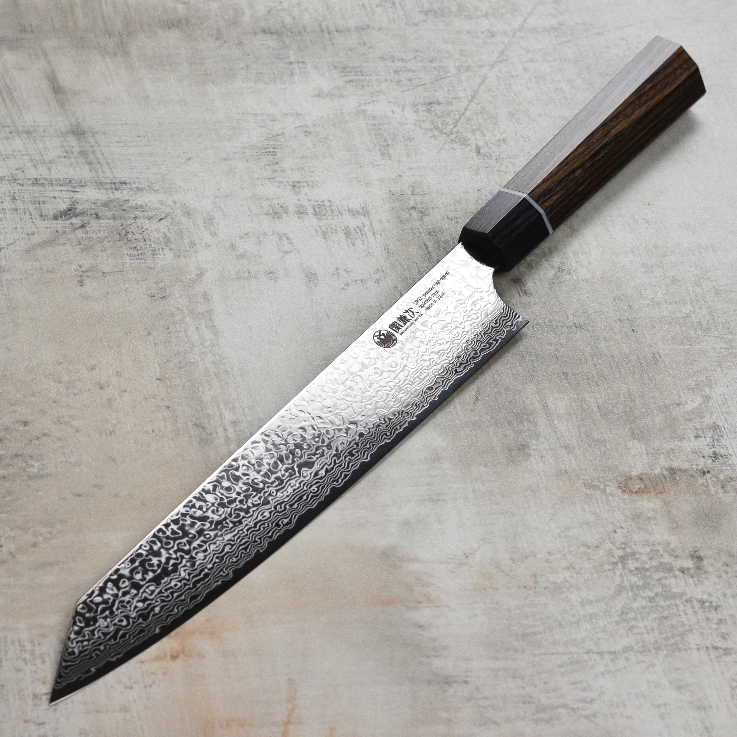 Seki Kanetsugu Zuiun SG2 Sujihiki Chef Knife in action, slicing through fresh vegetables.