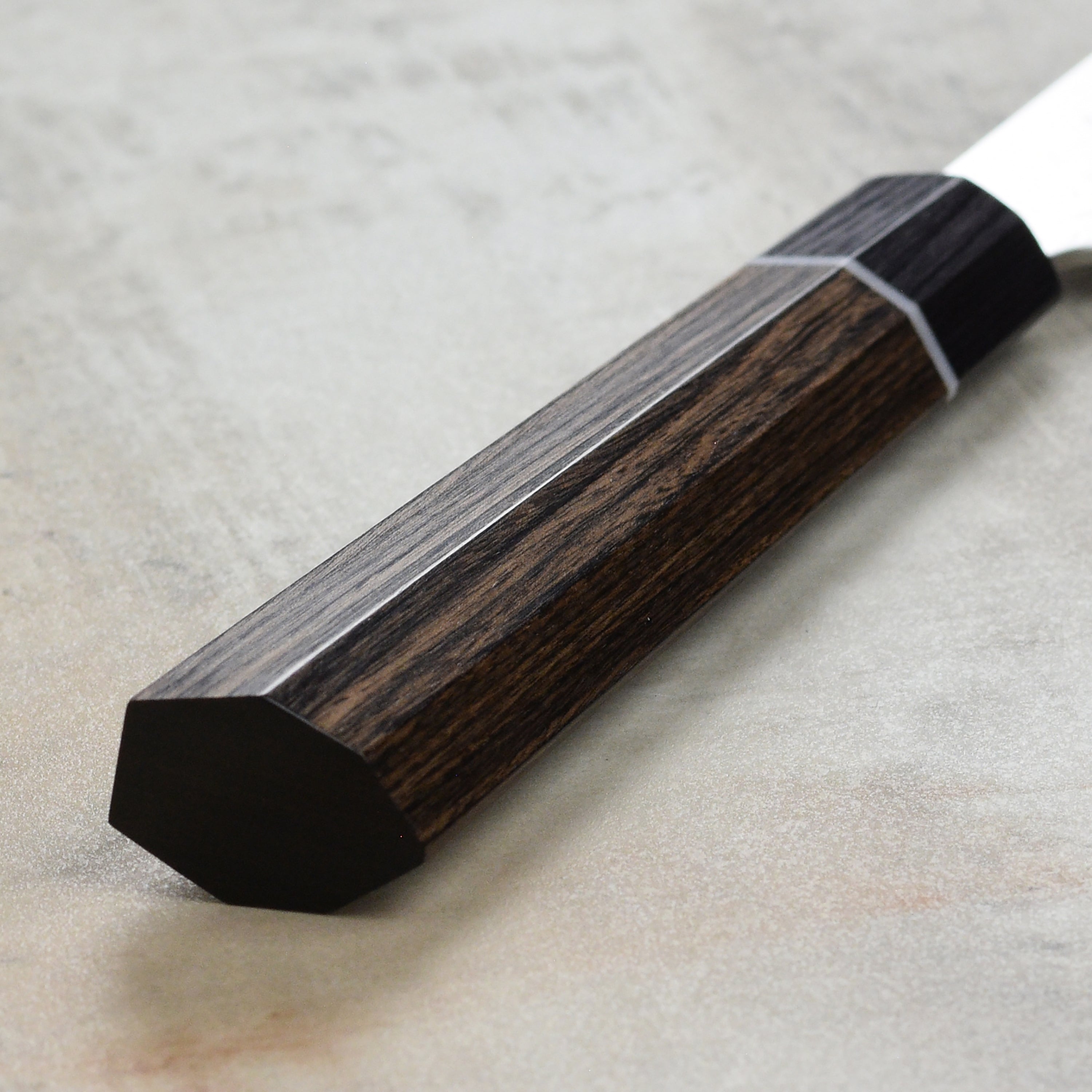 Close-up of the Seki Kanetsugu Zuiun SG2 Sujihiki Chef Knifes ergonomic handle for comfort.
