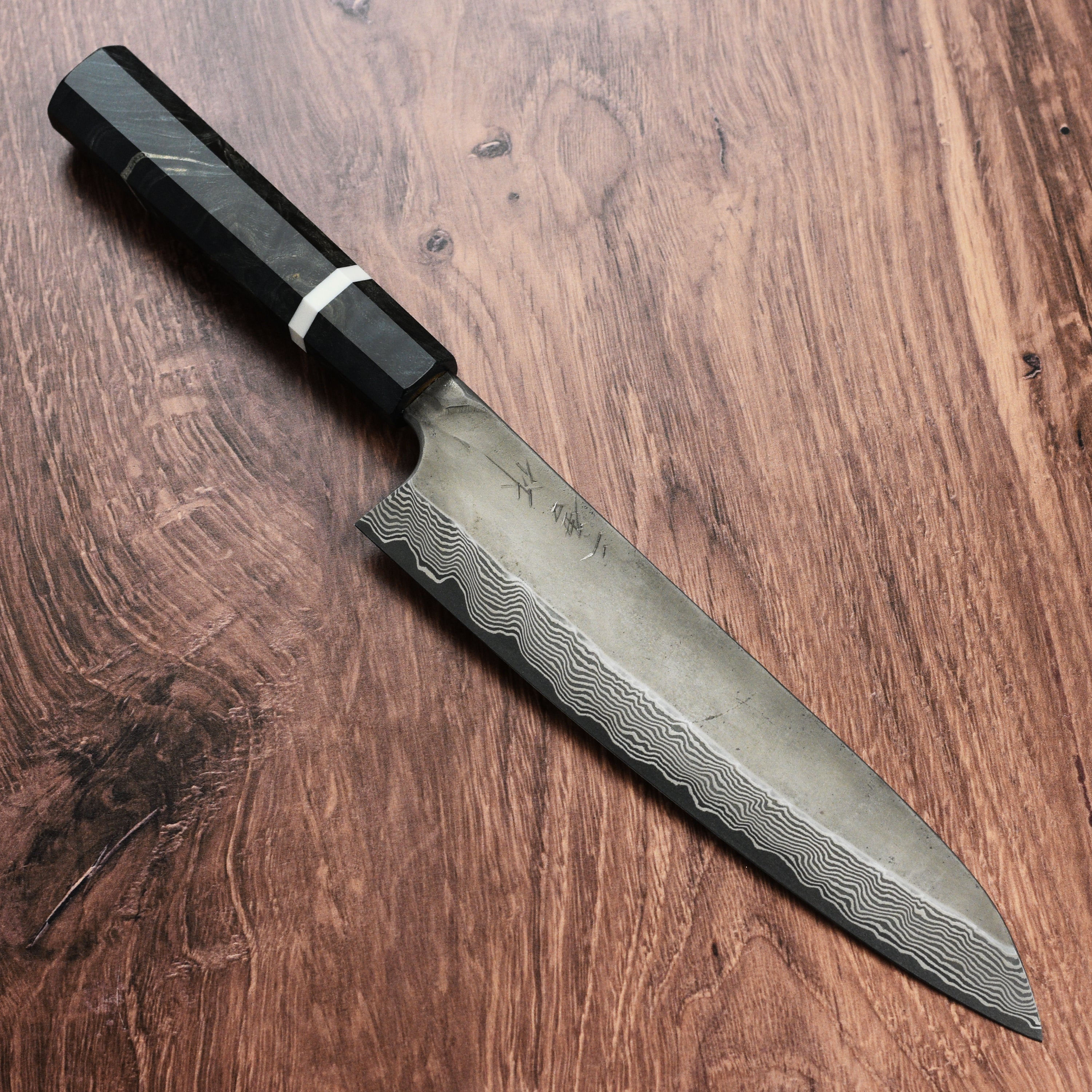 Japanese chef knife in action, slicing vegetables with the Nigara Ginsan Ginsan Kurozome Damascus steel blade