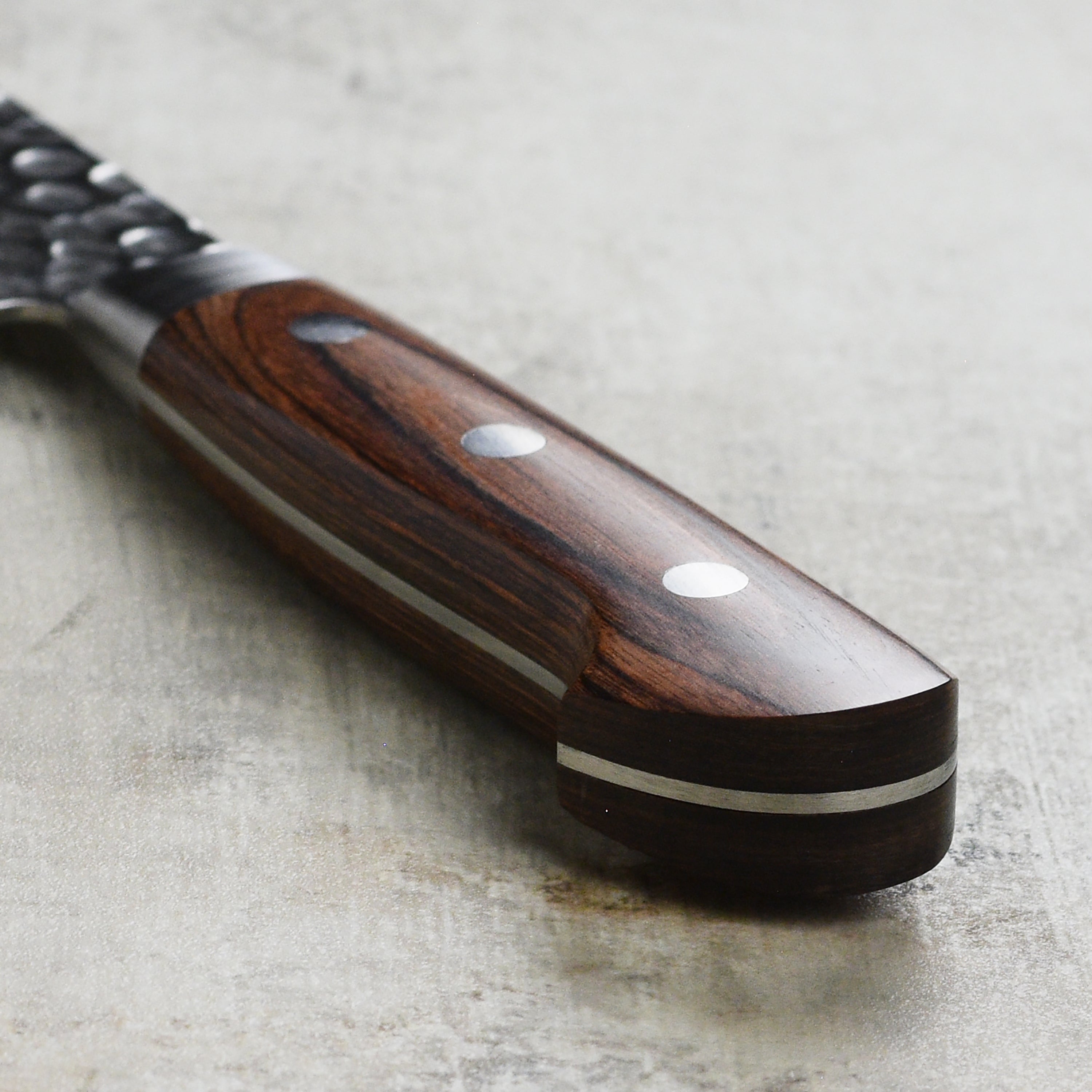 Professional chef using the Ittetsu gyuto knife for precision slicing in a modern kitchen.
