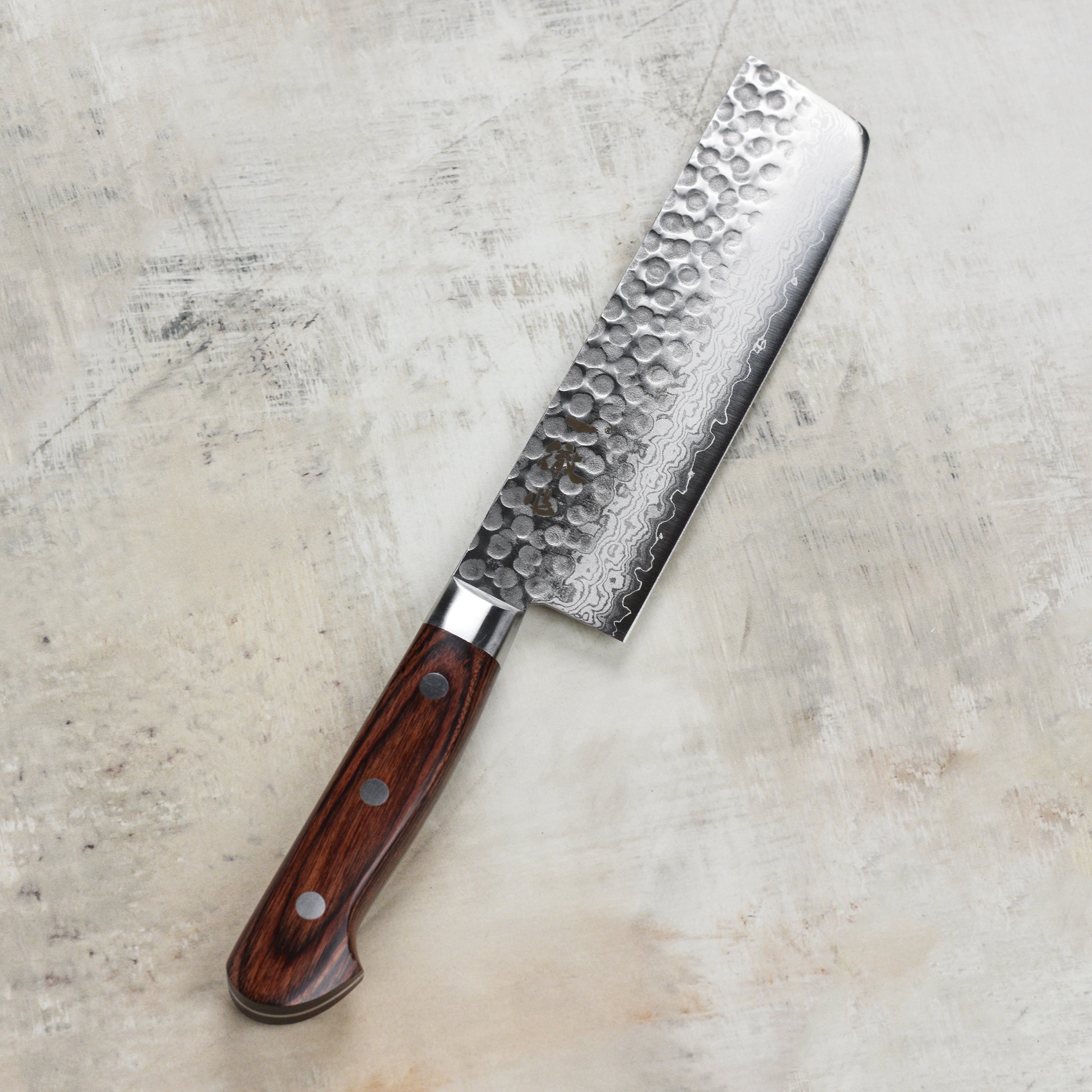 Close-up of the edge of the nakiri knife demonstrating its cutting precision.