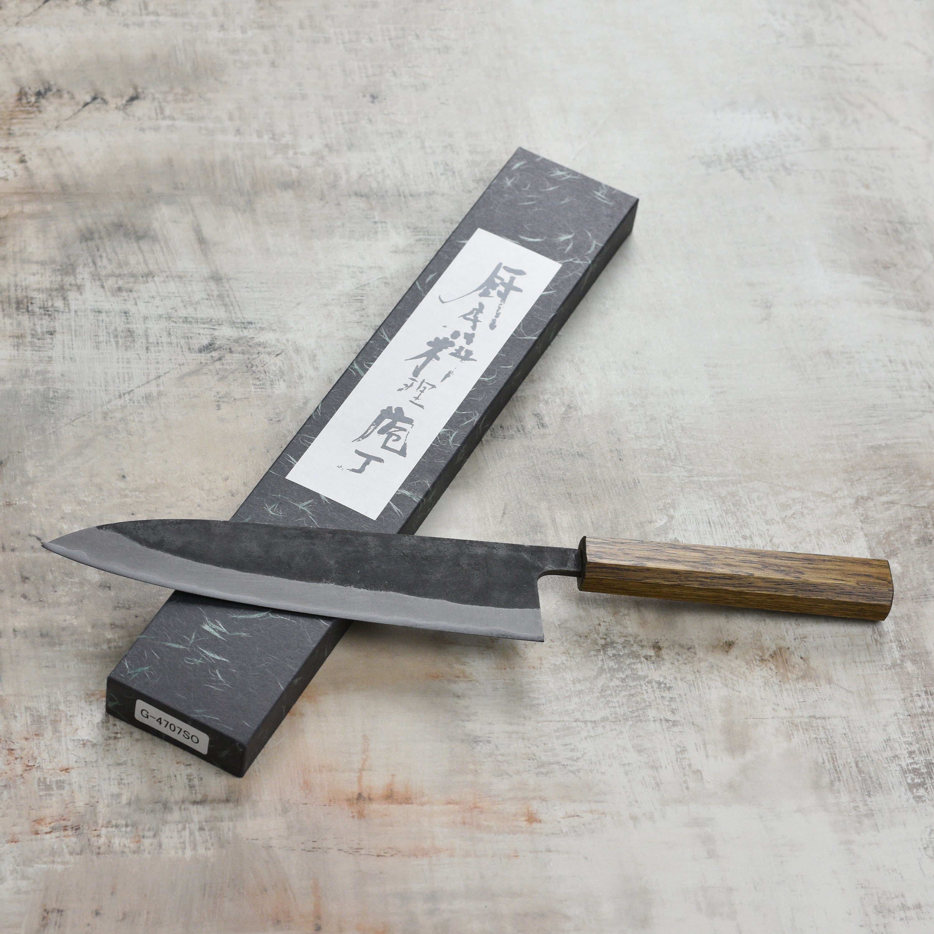 Close-up of the Shiro Kamo Aogami Super Gyutos sharp stainless steel blade, highlighting craftsmanship