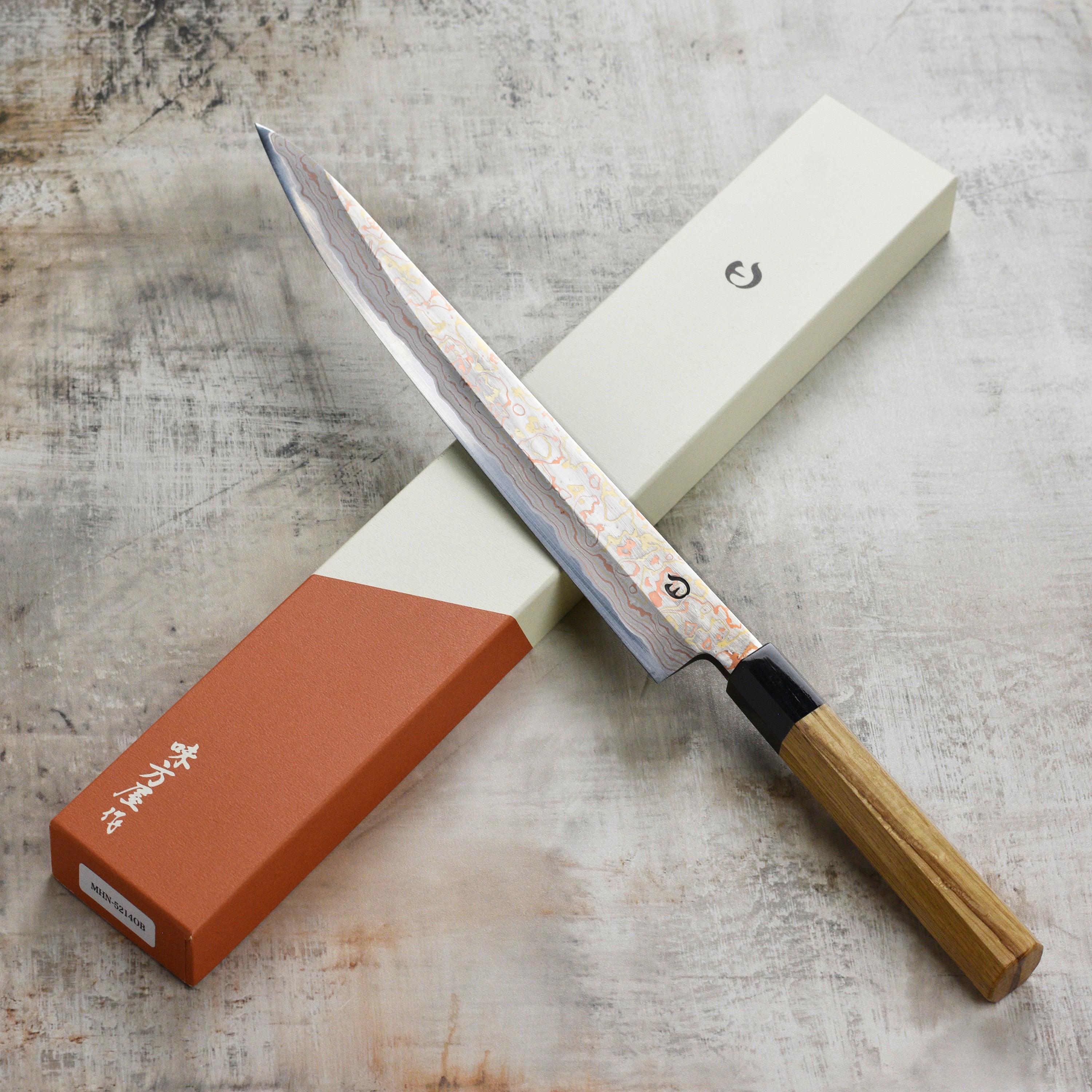Close-up of Hinoura Damascus sujihiki blade showcasing intricate Damascus steel pattern