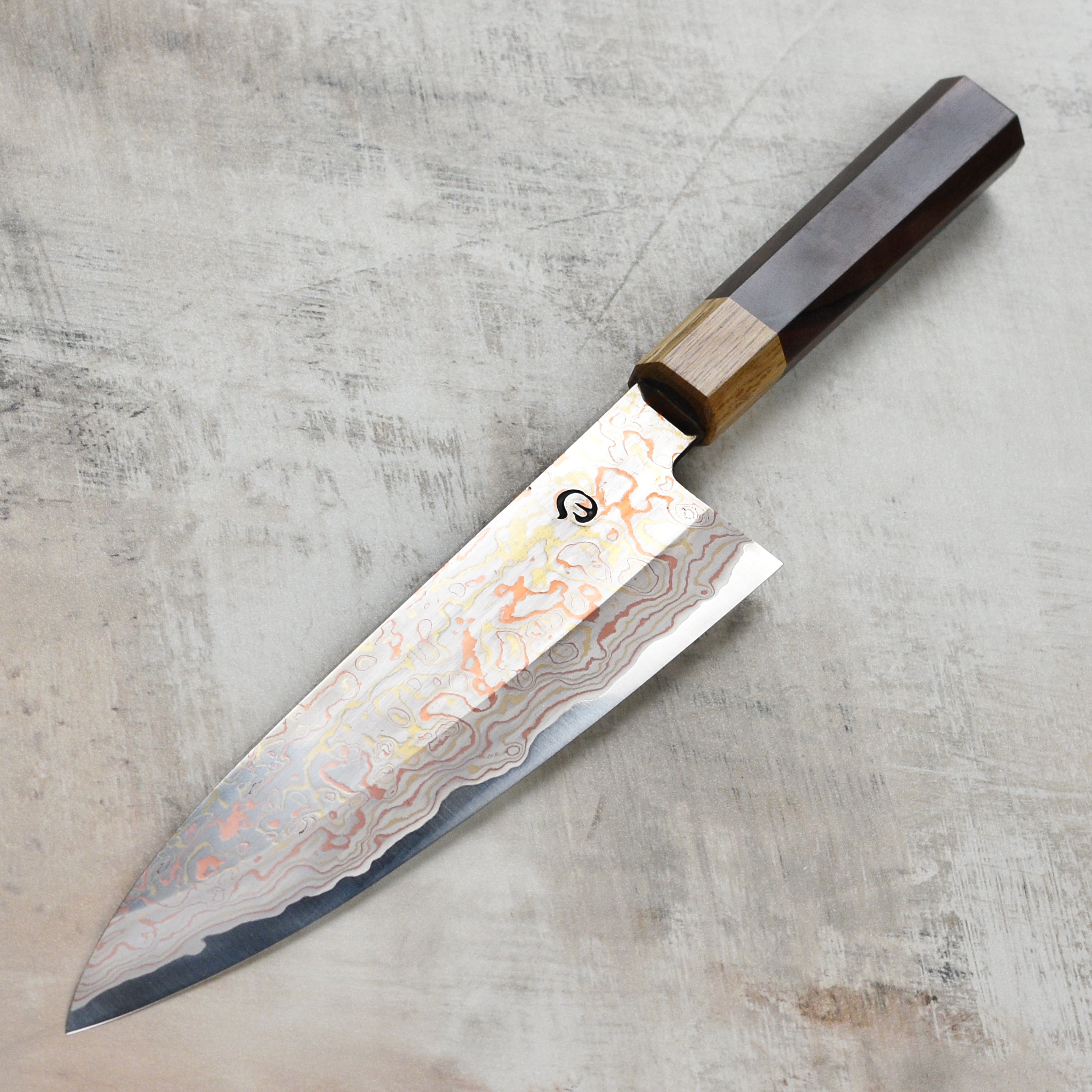Hinoura Aogami #2 Gyuto knife from above, highlighting its sharp blade and Damascus pattern.