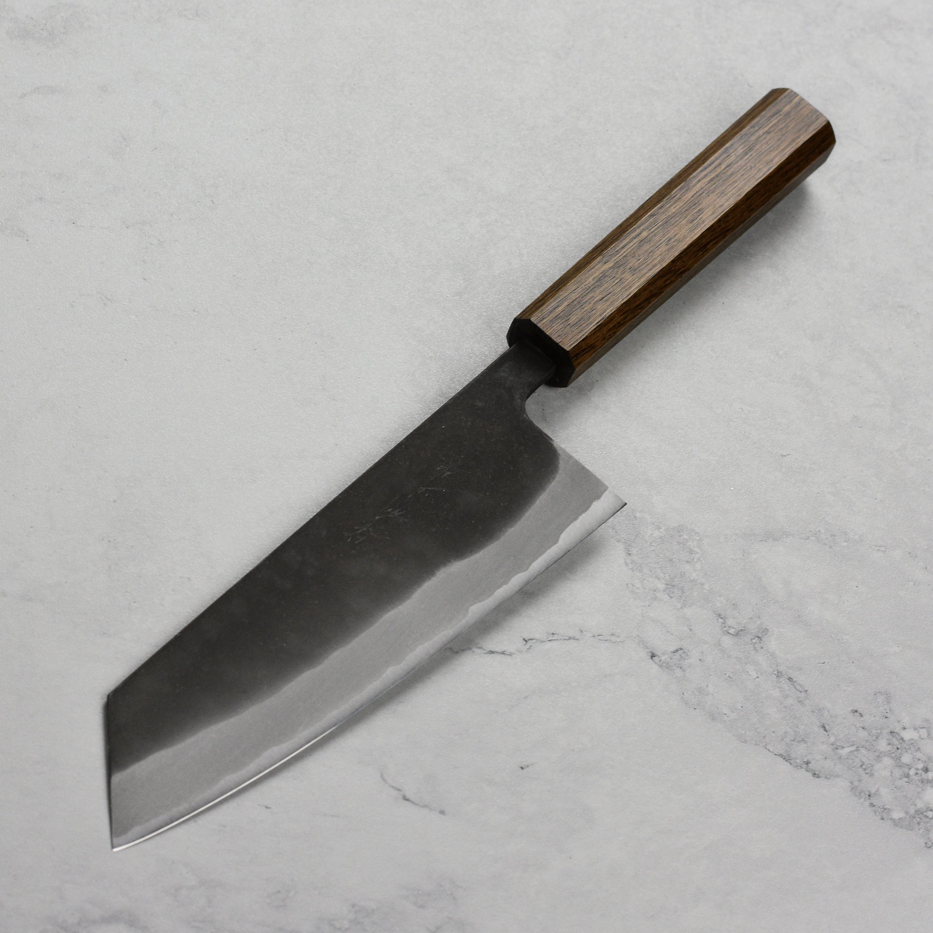 Close-up of Shiro Kamo Aogami Bunka knife blade highlighting its sharpness and craftsmanship.