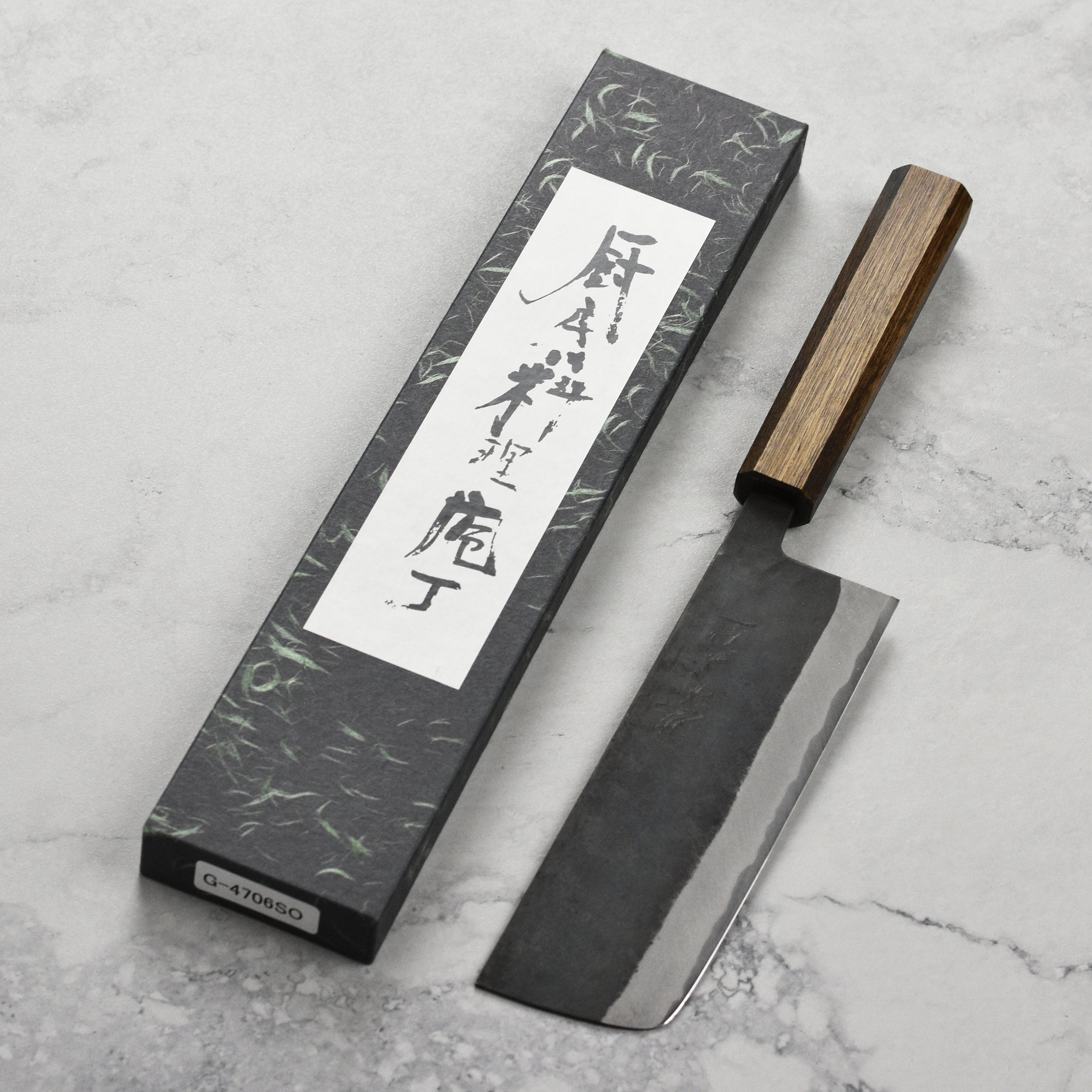 Close-up of the Shiro Kamo Nakiri knife blade showing Kurouchi finish