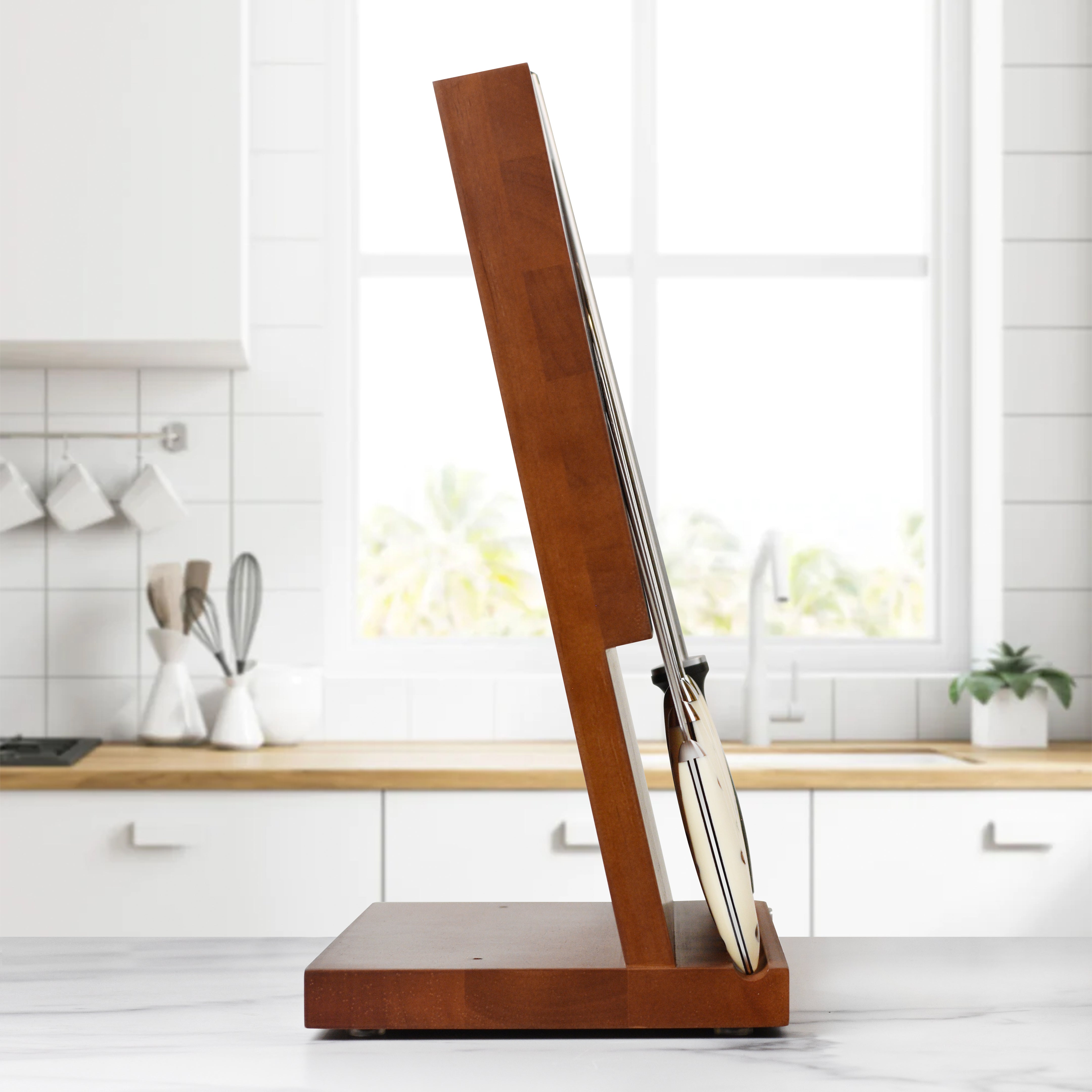 Chef using Kramer Cumulus knife for precision slicing in a modern kitchen
