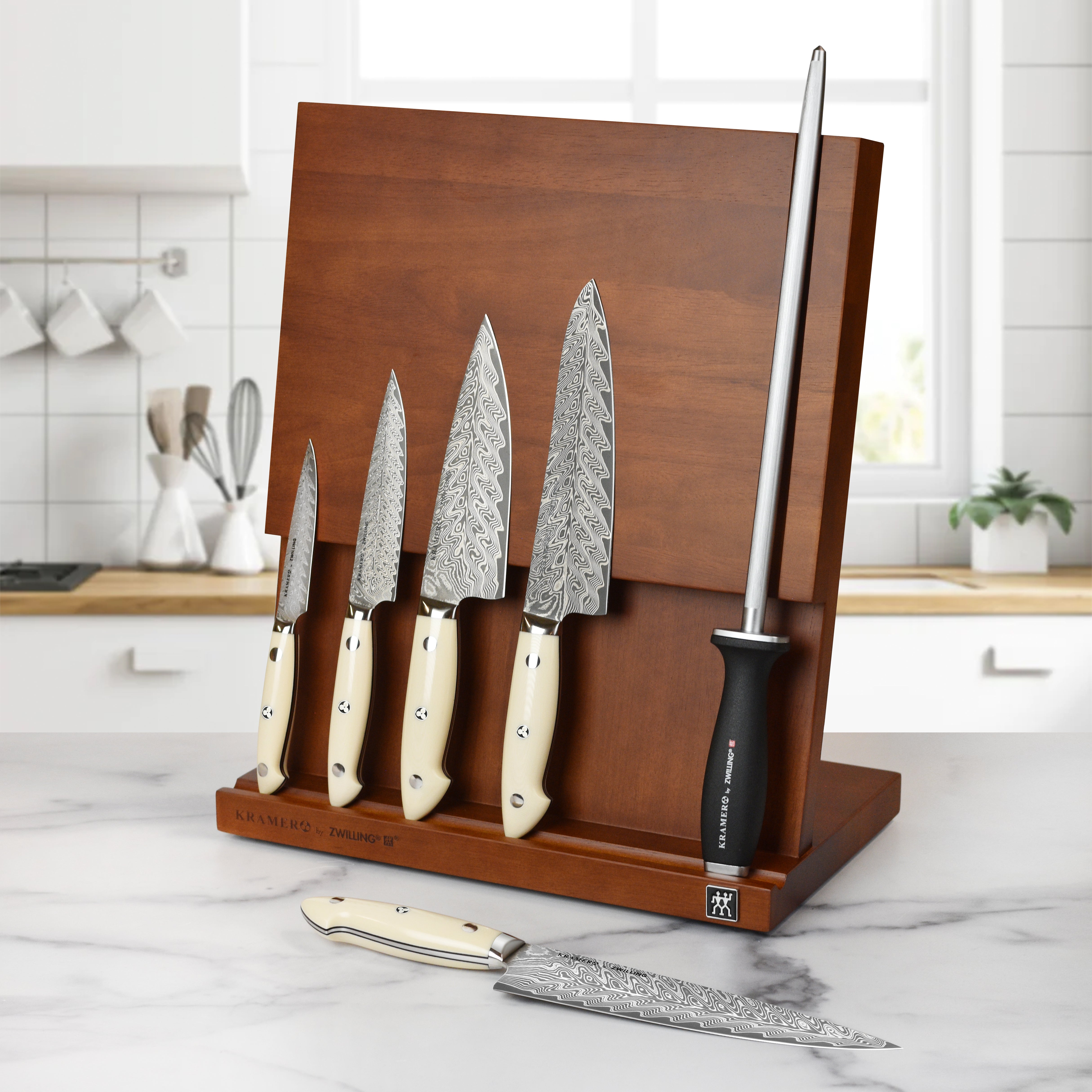 Chef using Kramer Cumulus knife for precision slicing in a modern kitchen