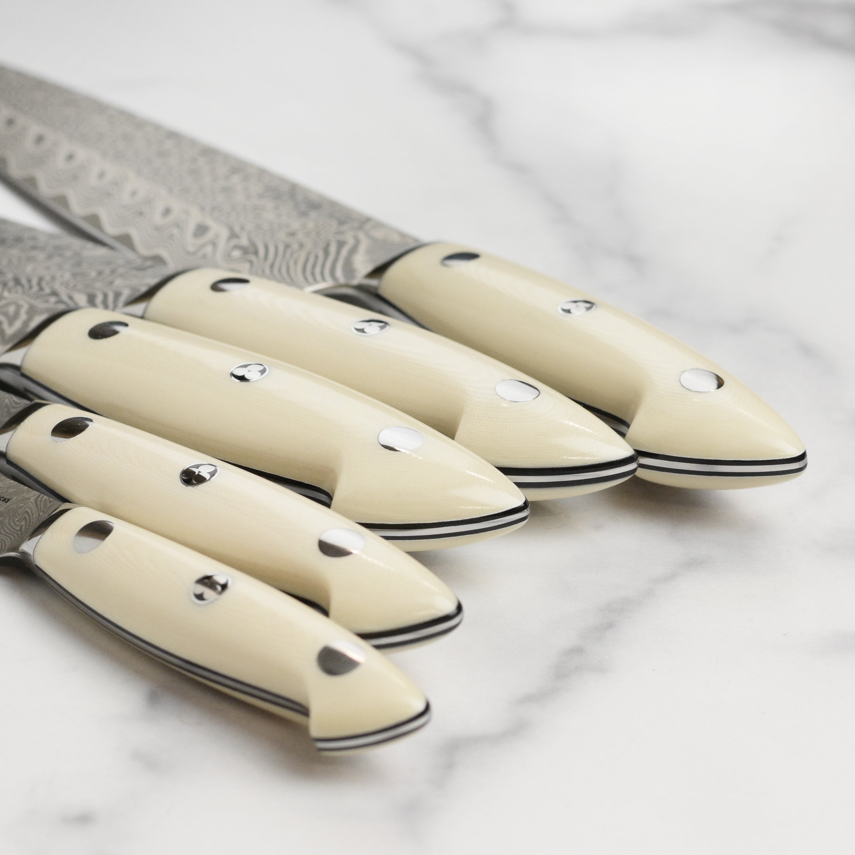 Display of the 7-piece luxury knife set on a wooden block with handles