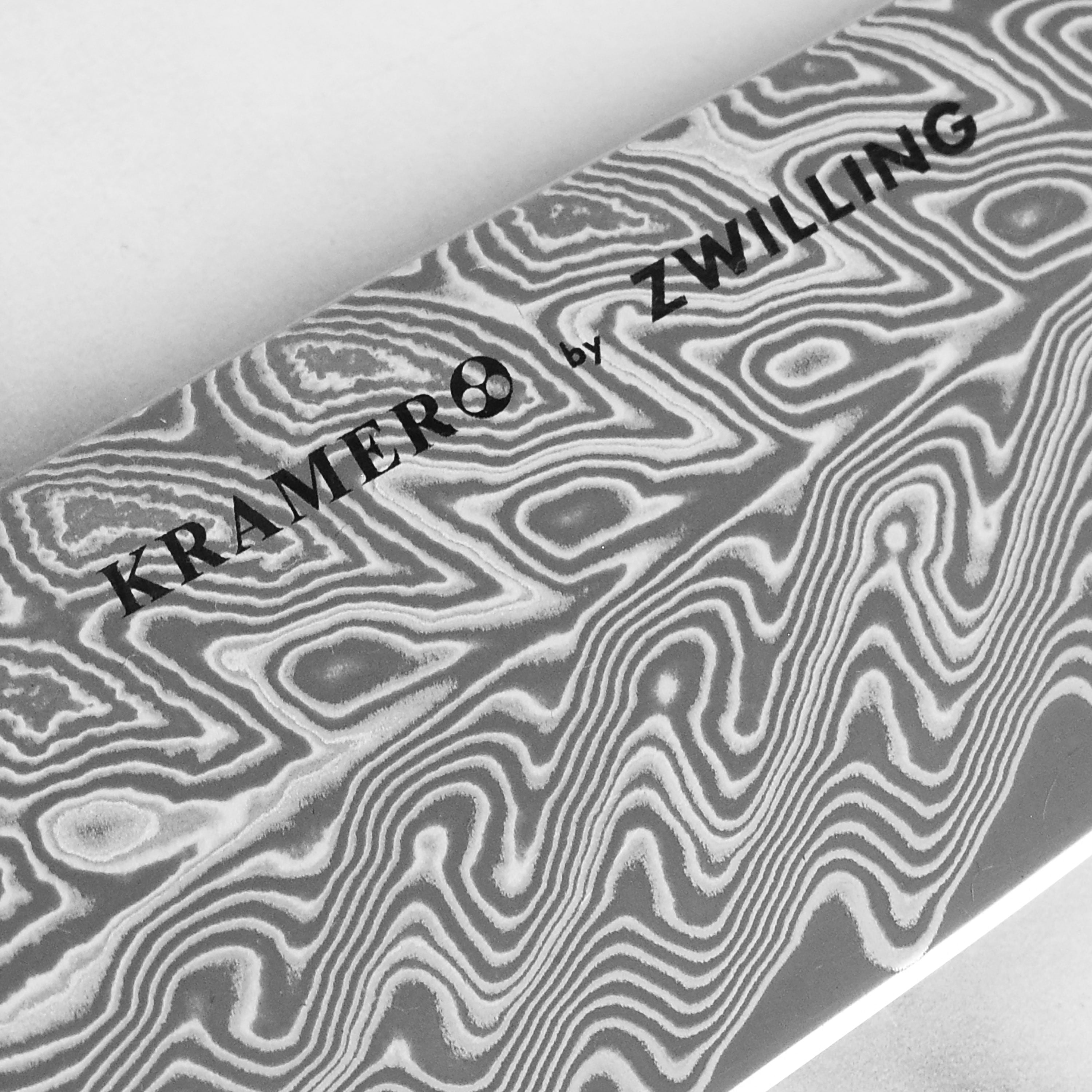 Close-up of the blade edge of the SG2 steel santoku knife, highlighting its sharpness and craftsmanship.