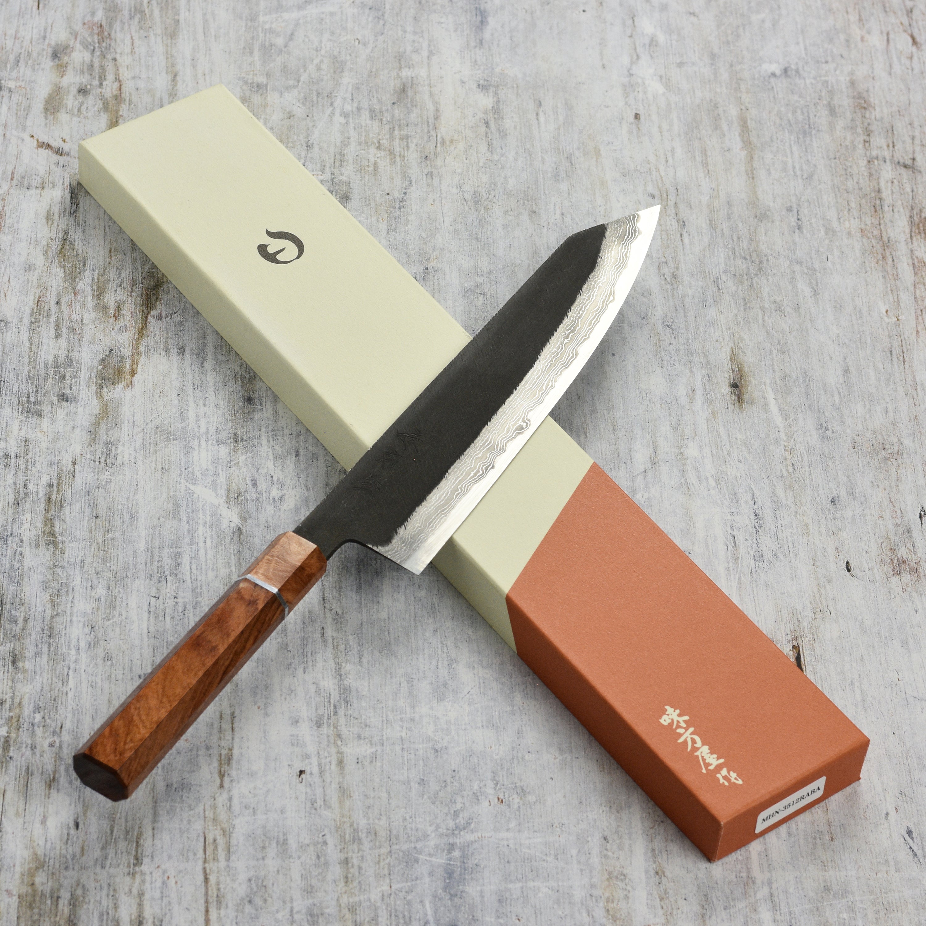 Premium Shirogami kiritsuke knife showcasing its sharp blade and ergonomic handle from a side angle.