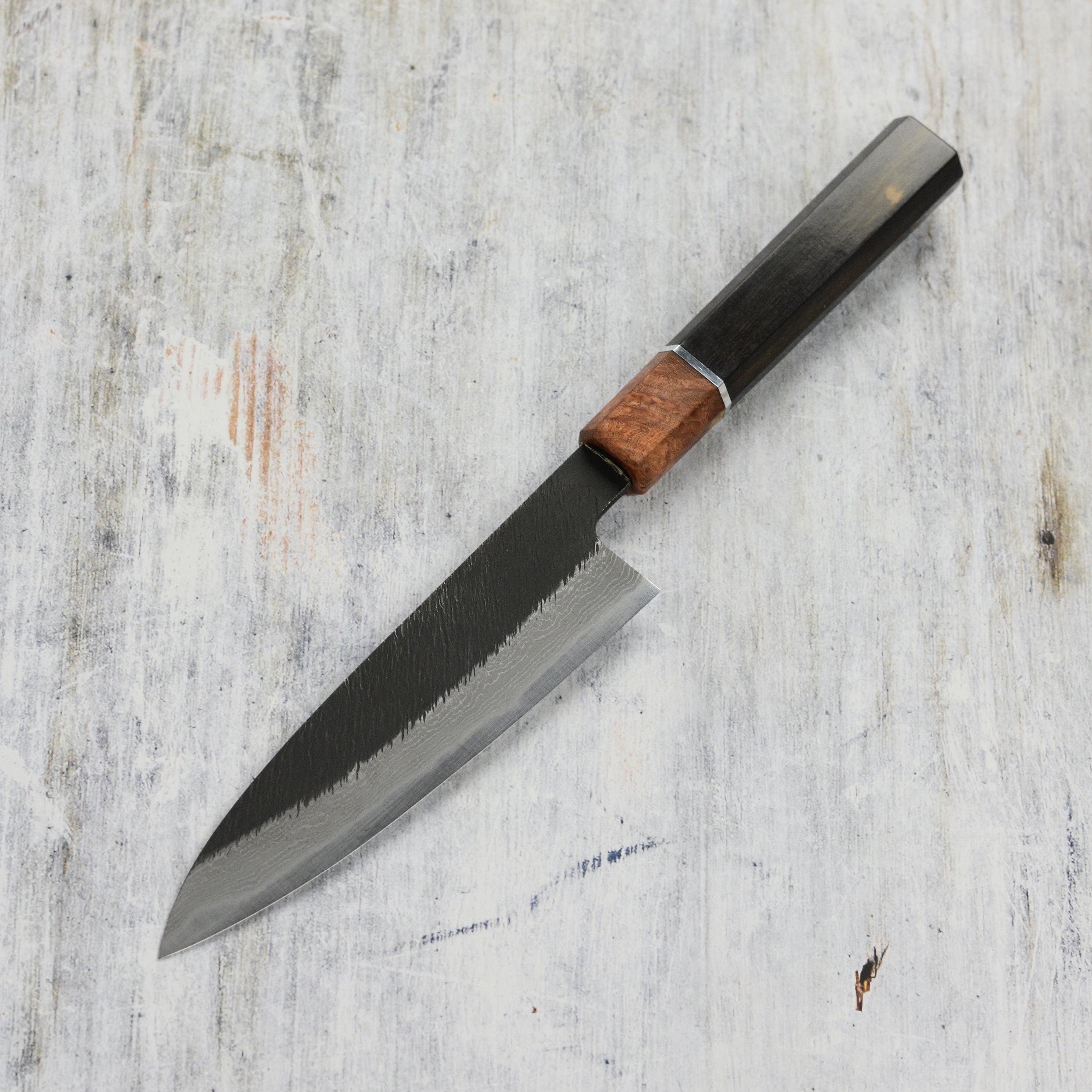 Chef using a high-quality Japanese kitchen knife for precise slicing