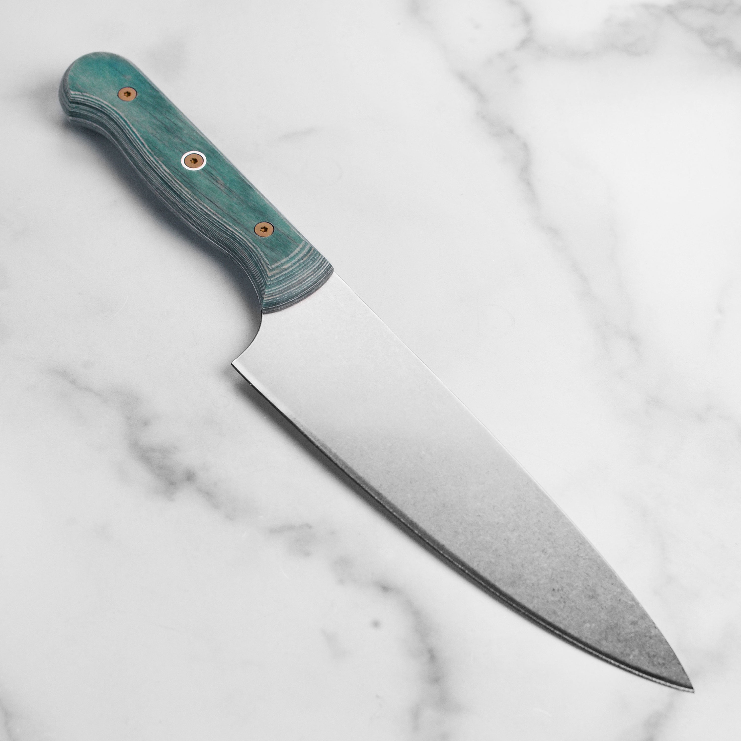 Chef slicing vegetables with the German chefs knife on a cutting board