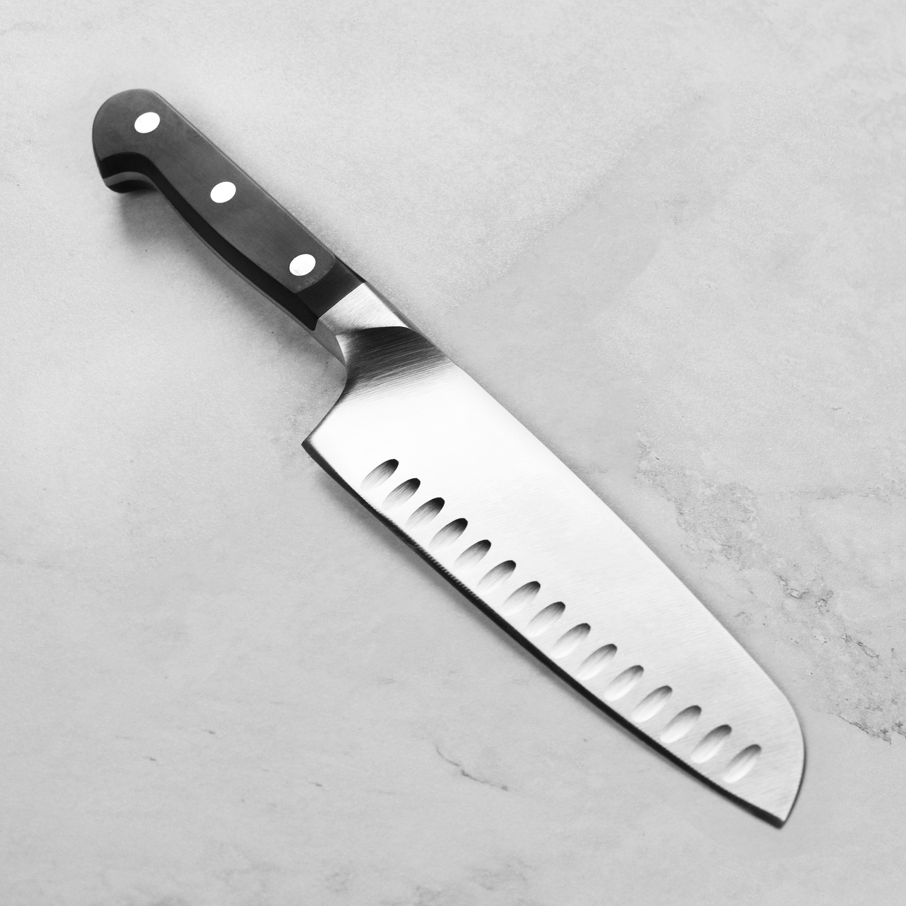 Close-up of the blade of Zwilling Pro 7-inch Santoku knife highlighting high-quality craftsmanship