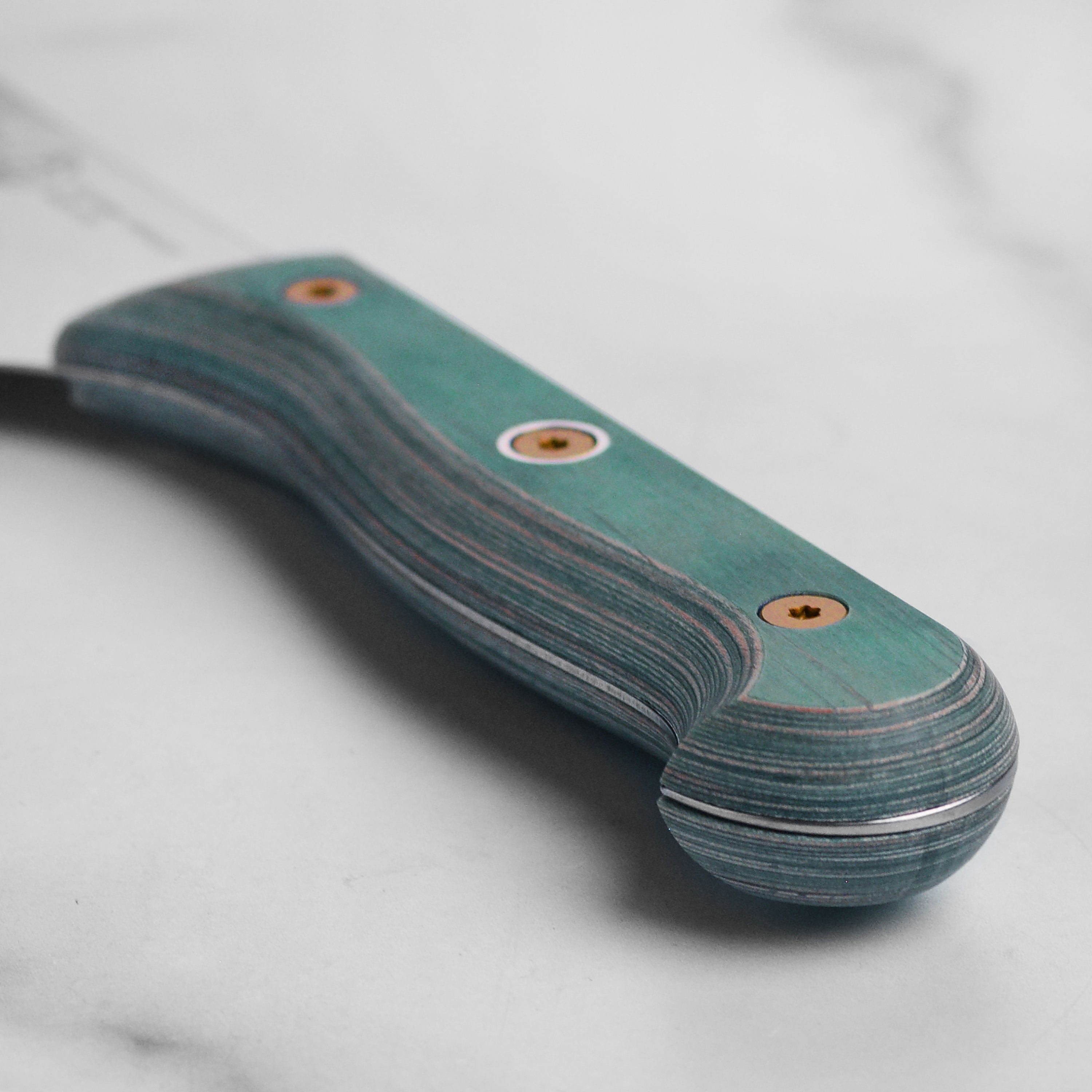 Close-up of the Messermeister Nakiri knife in use, expertly slicing vegetables on a wooden cutting board.