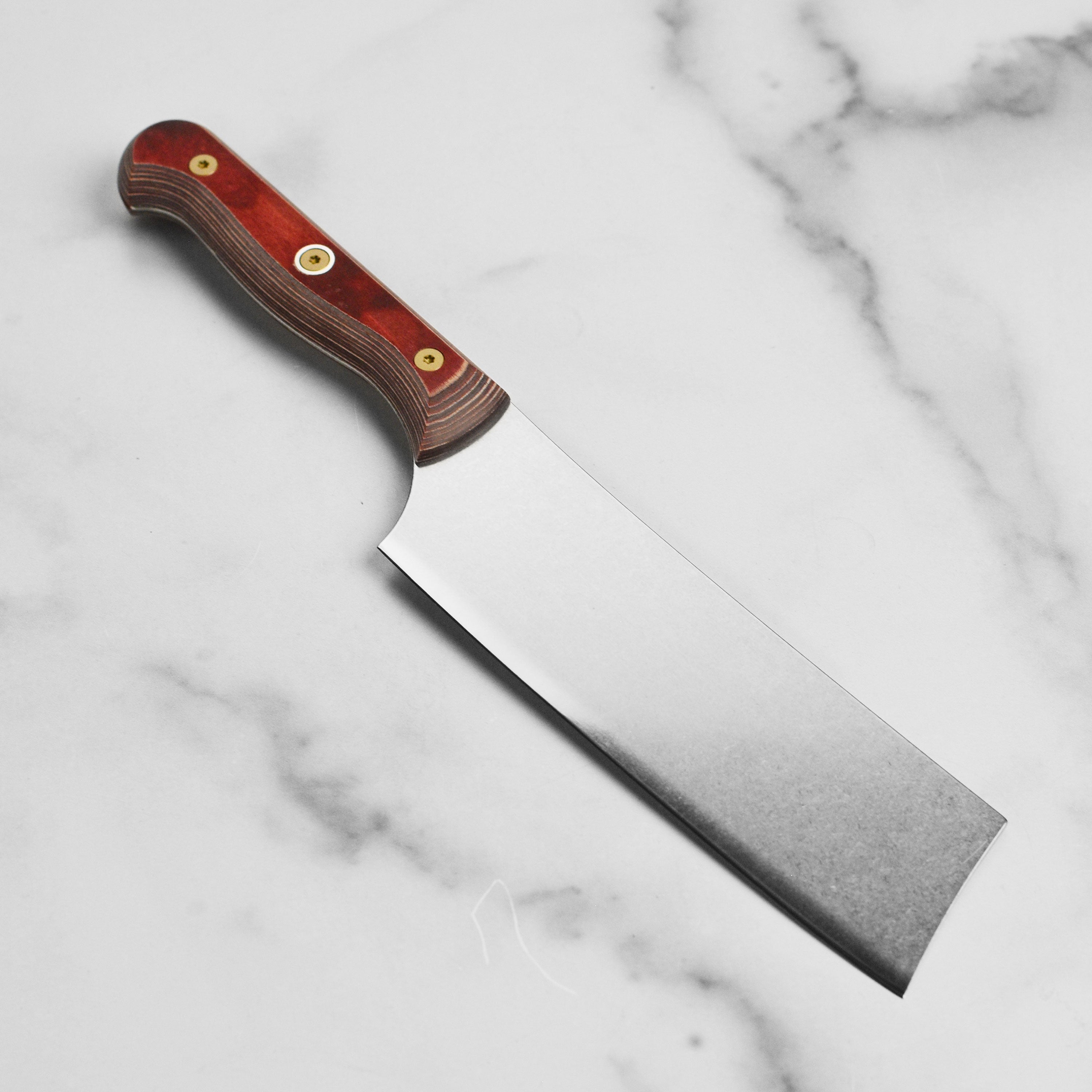 Kitchen cleaver in action chopping fresh vegetables