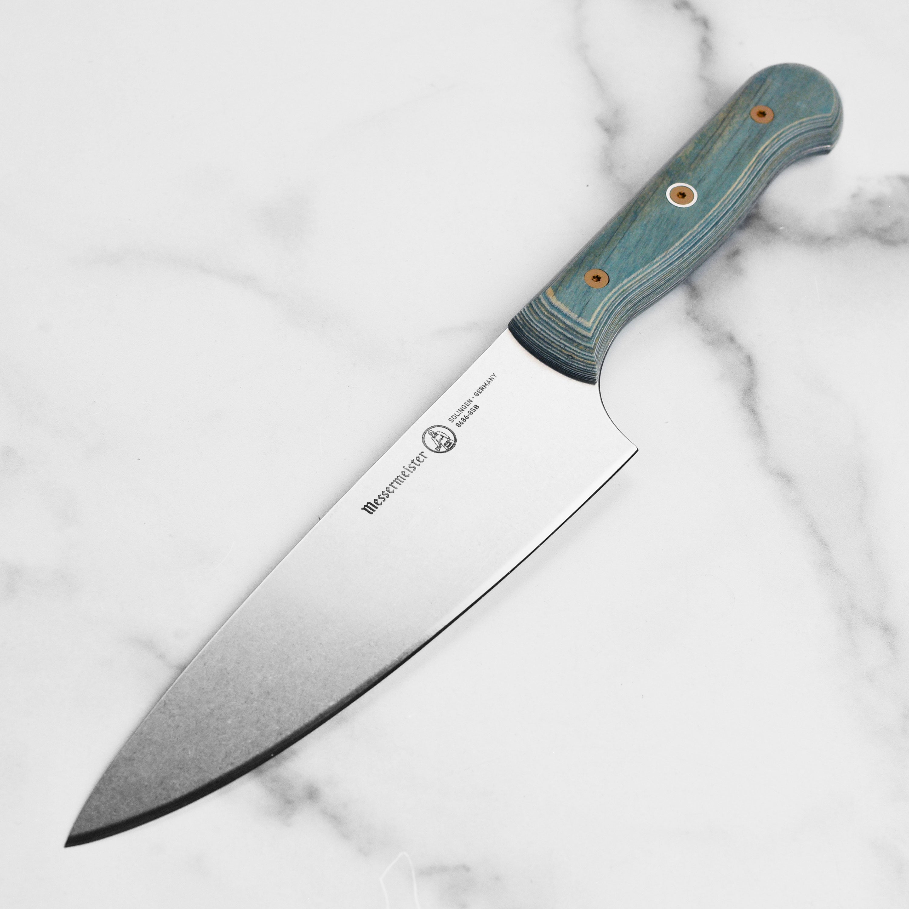 Close-up of the Messermeister Custom Indigo German chef's knife blade showing stonewash finish