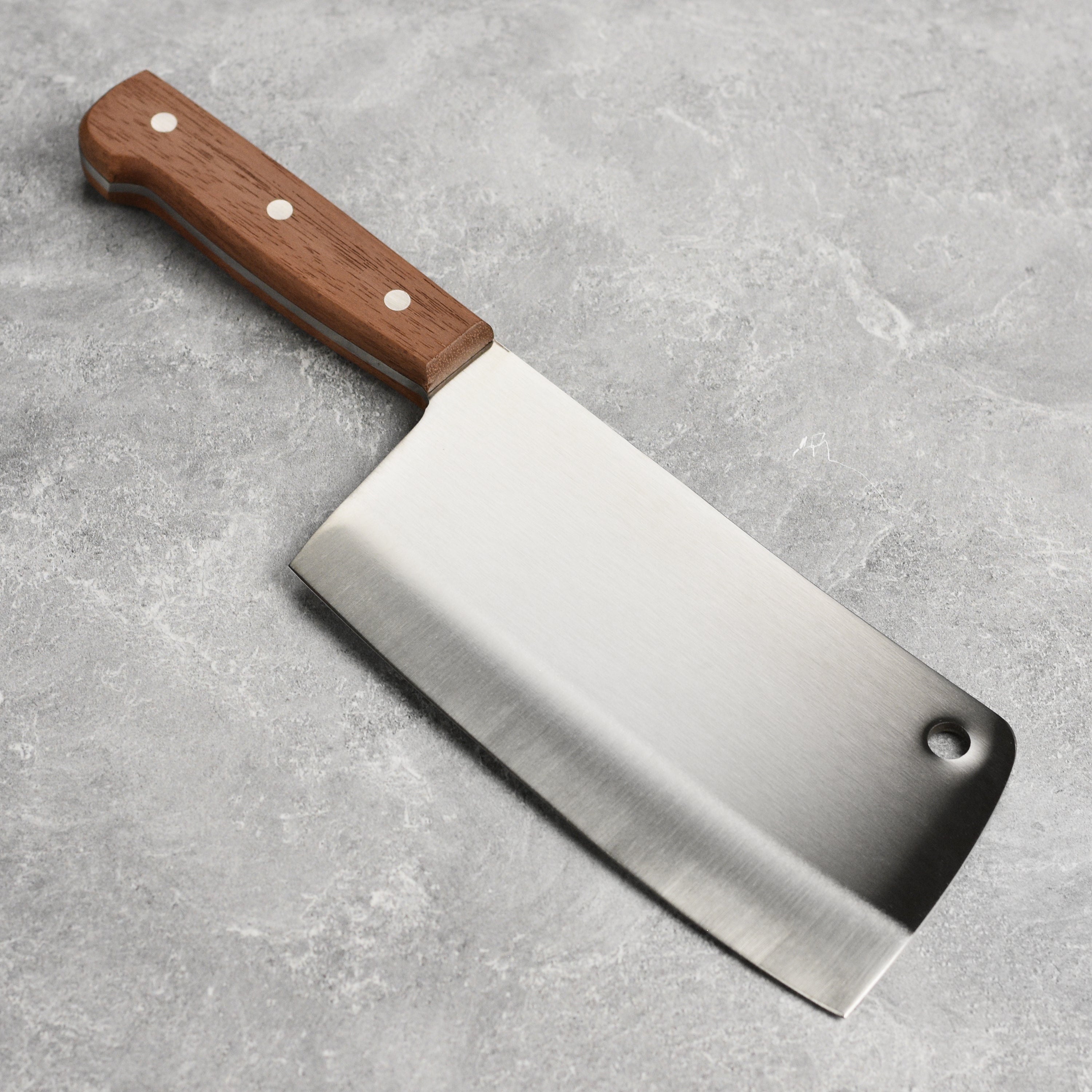 Suncraft meat cleaver placed next to various kitchen knives, highlighting its premium quality.