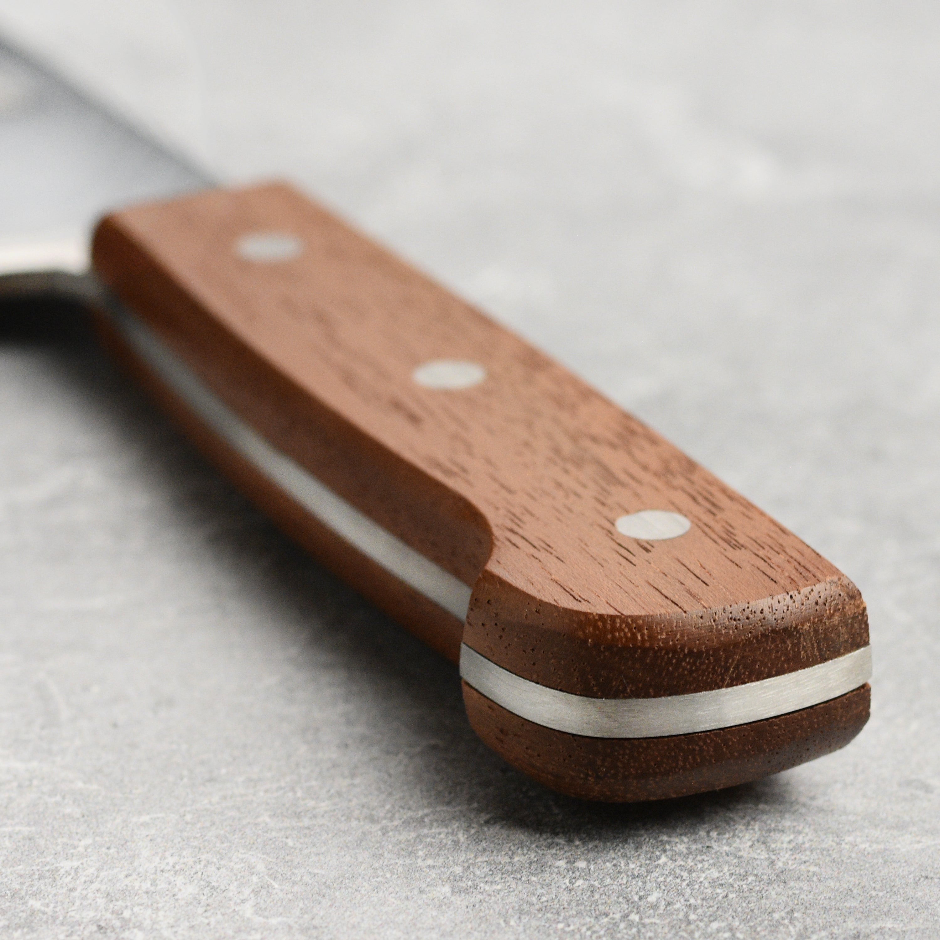 Close-up of the Suncraft 7-inch meat cleaver, showcasing its sharp blade and ergonomic handle.