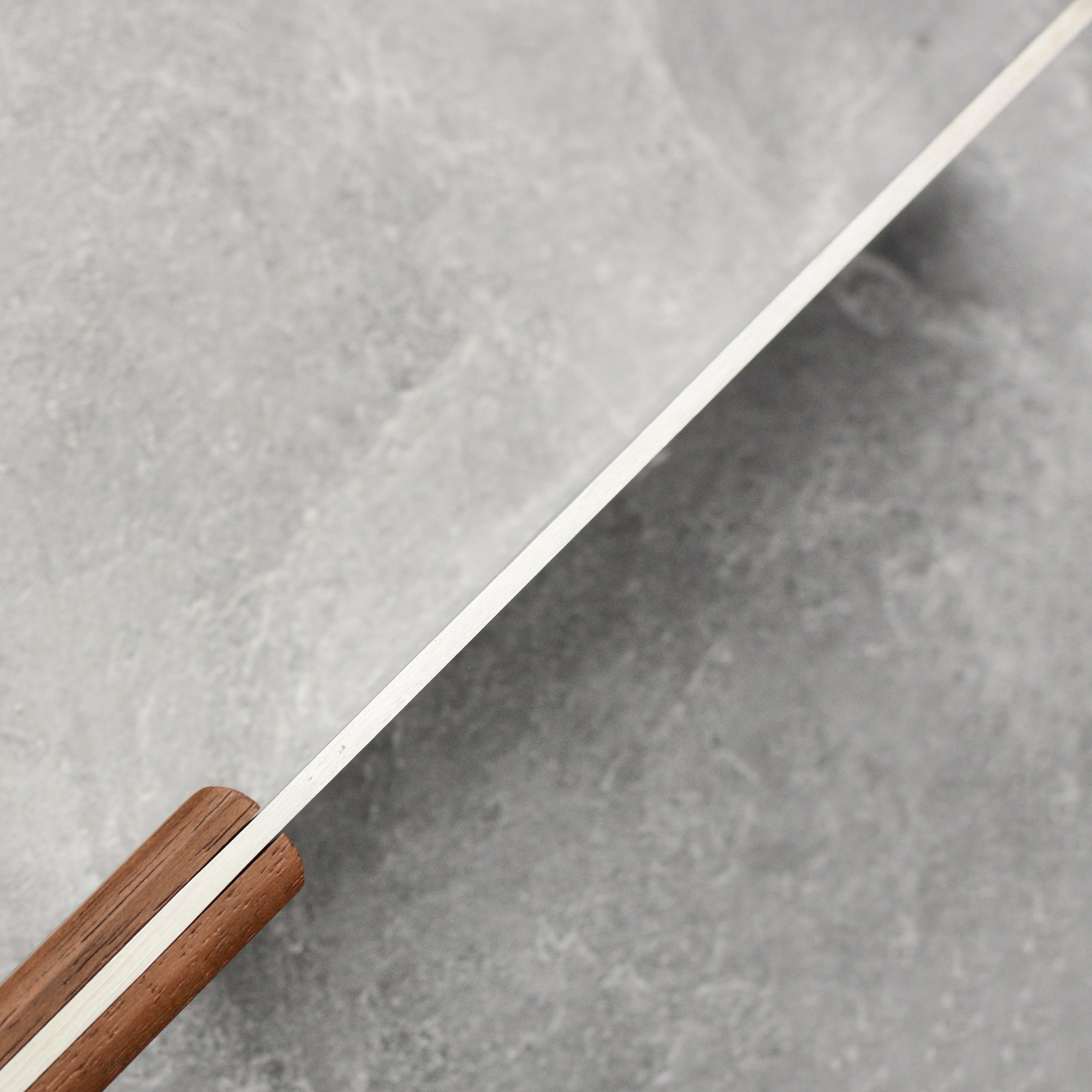Suncraft meat cleaver placed next to various kitchen knives, highlighting its premium quality.