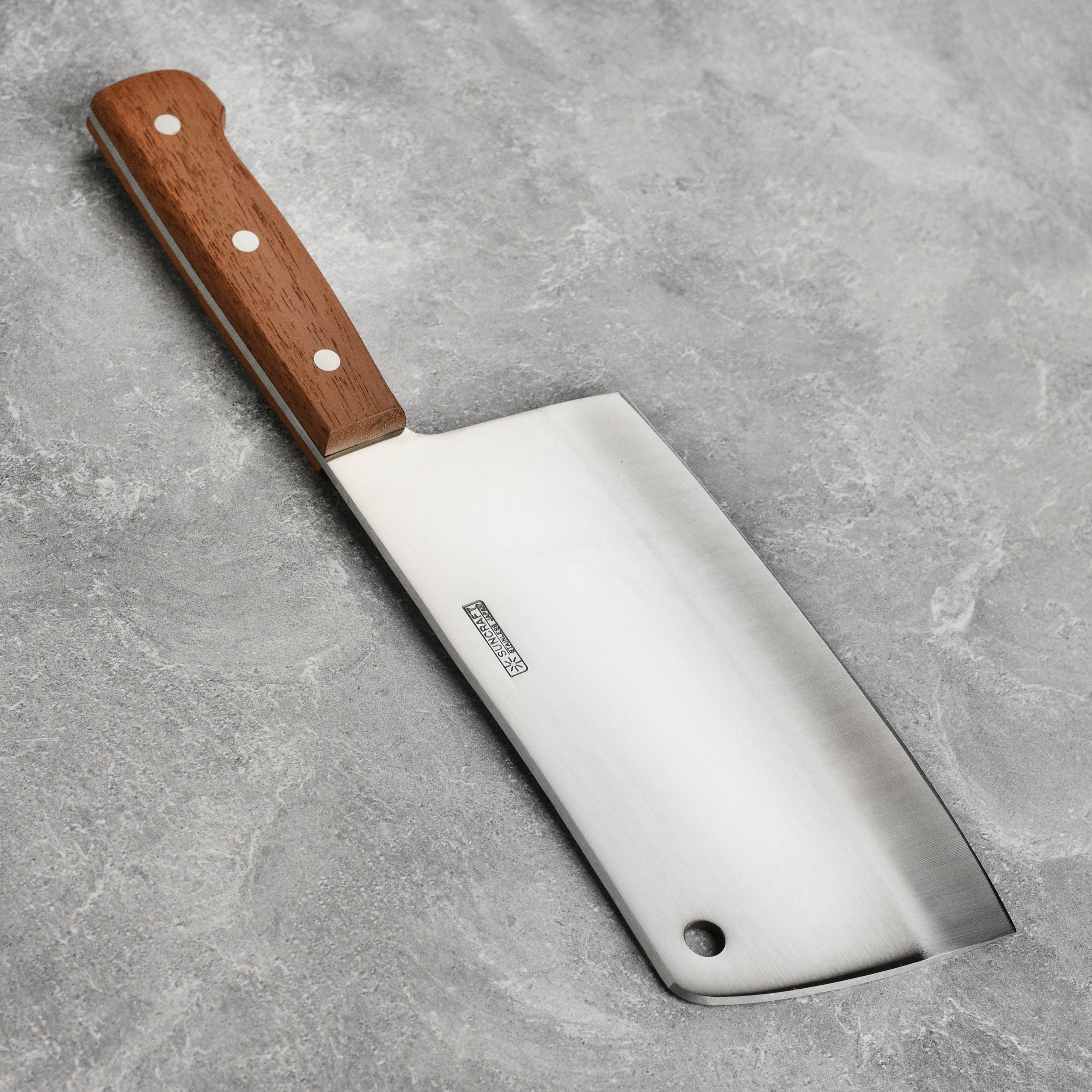 Close-up of the Suncraft 7-inch meat cleaver, showcasing its sharp blade and ergonomic handle.