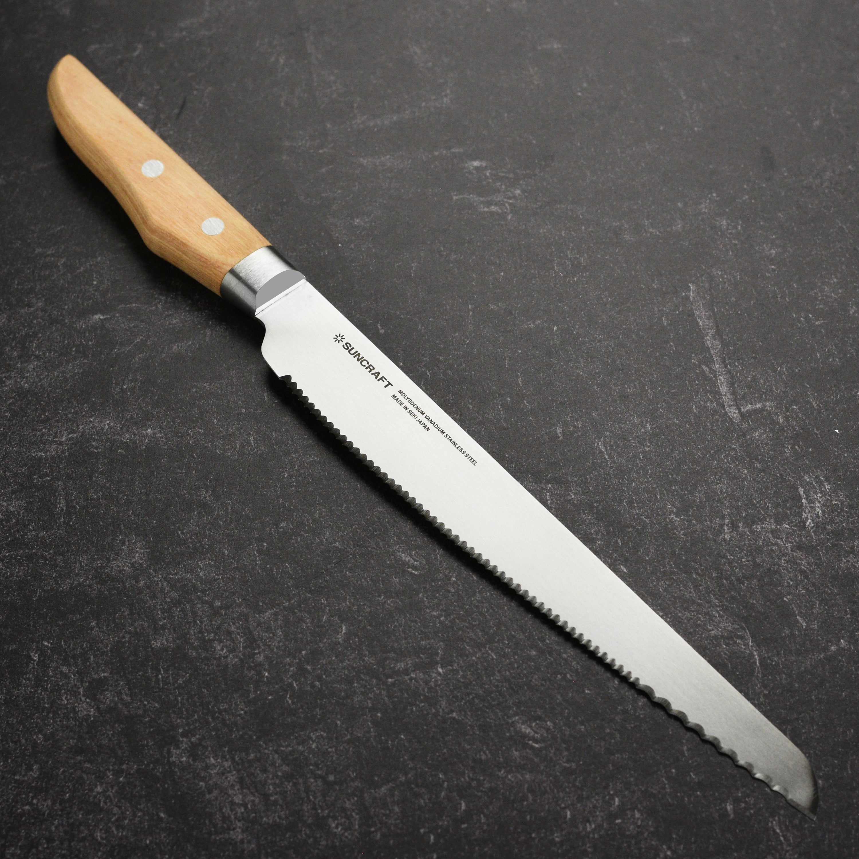 Suncraft Seseragi bread knife showcasing its serrated blade and pakkawood handle from a side angle.