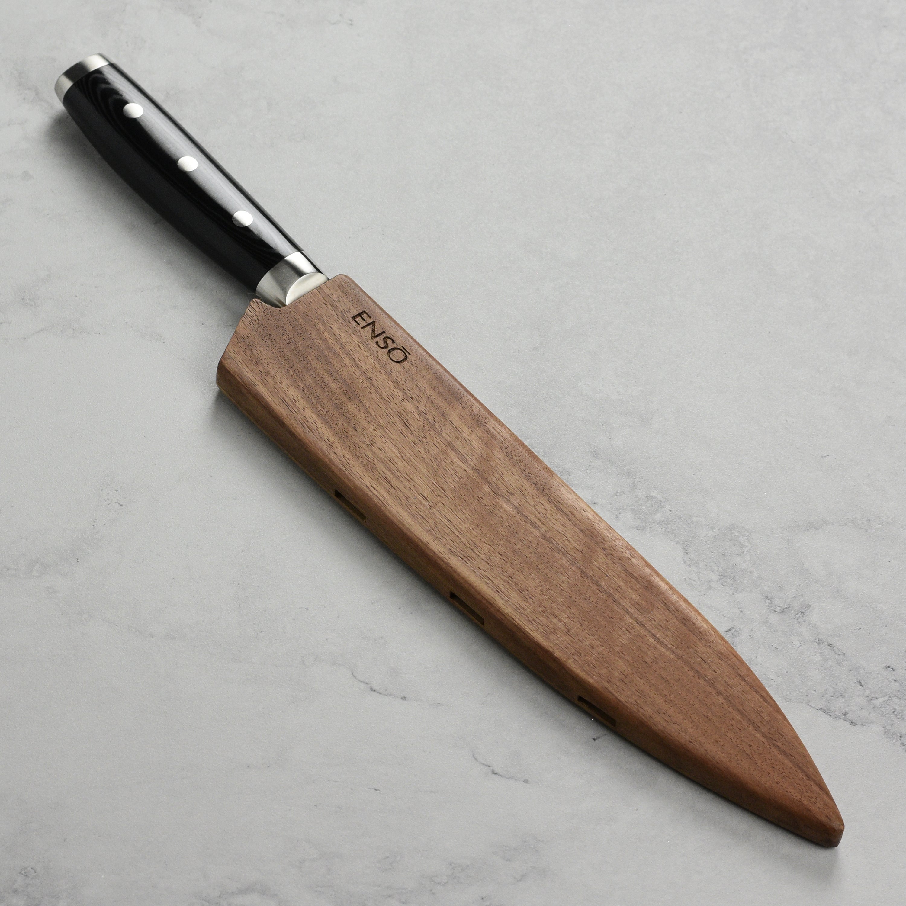 Side angle of the walnut knife sheath demonstrating the vent holes for airflow, ideal for knife preservation.