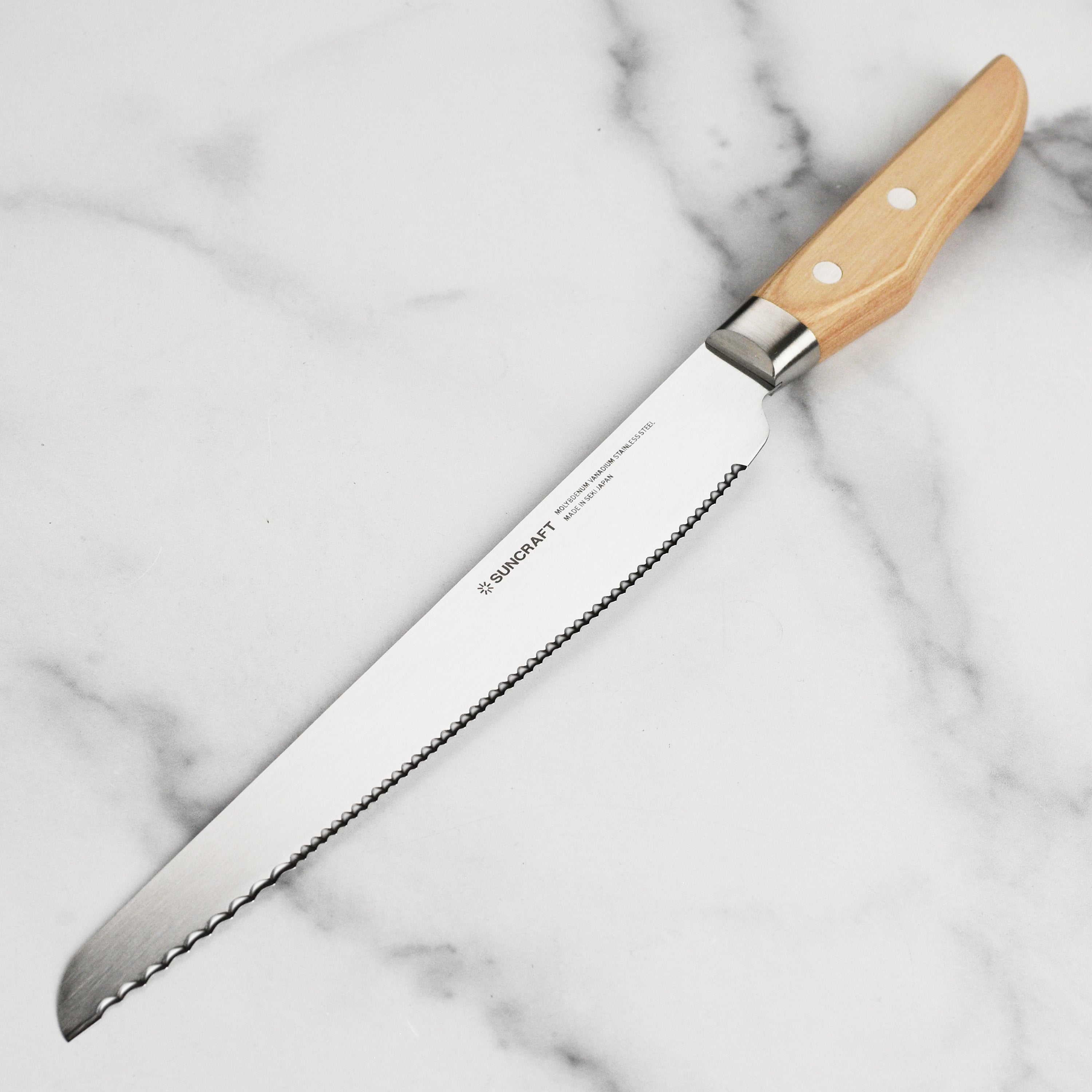 Close-up of Suncraft Seseragi bread knife showcasing serrated blade for left-handed users.