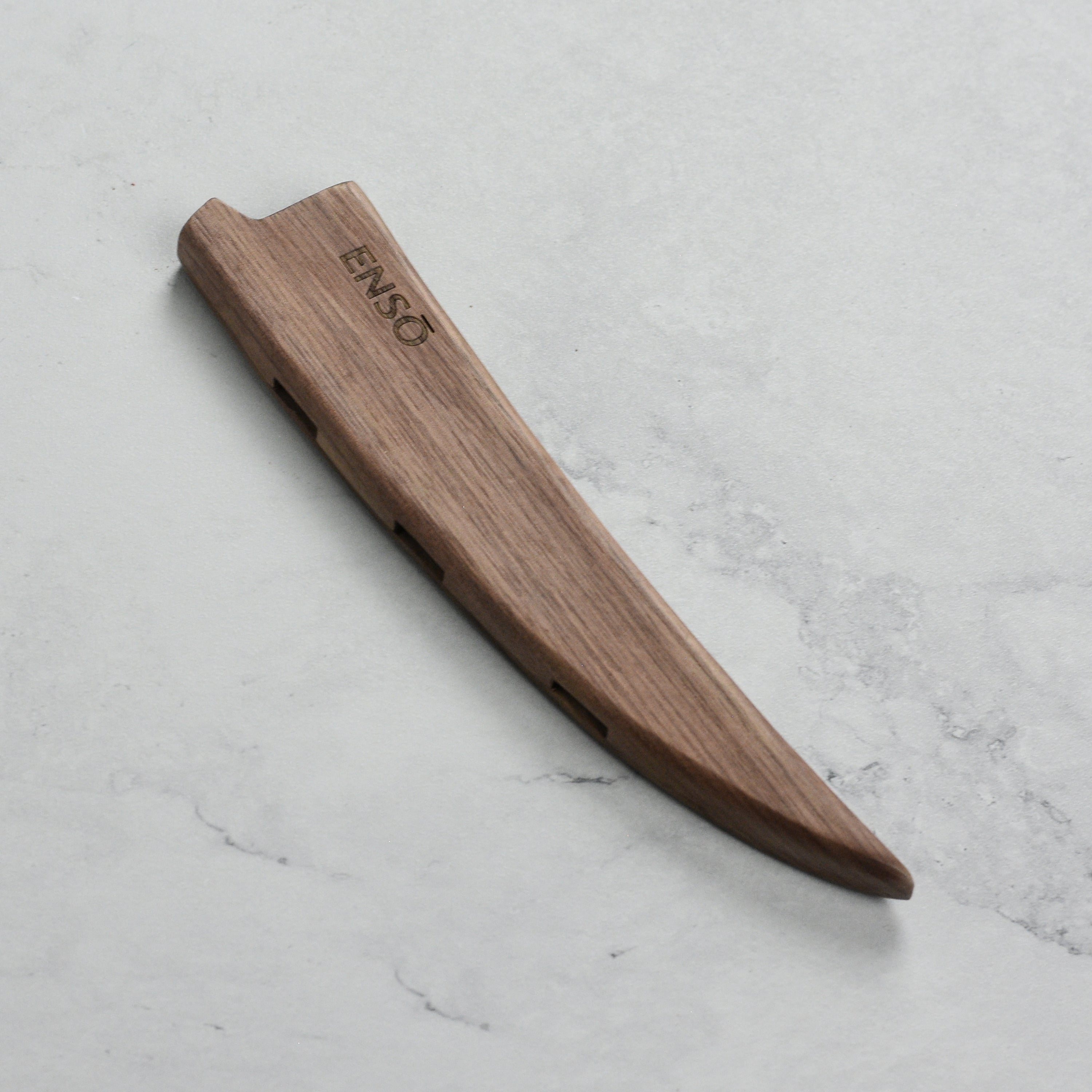 Walnut magnetic sheath holding a curved boning knife